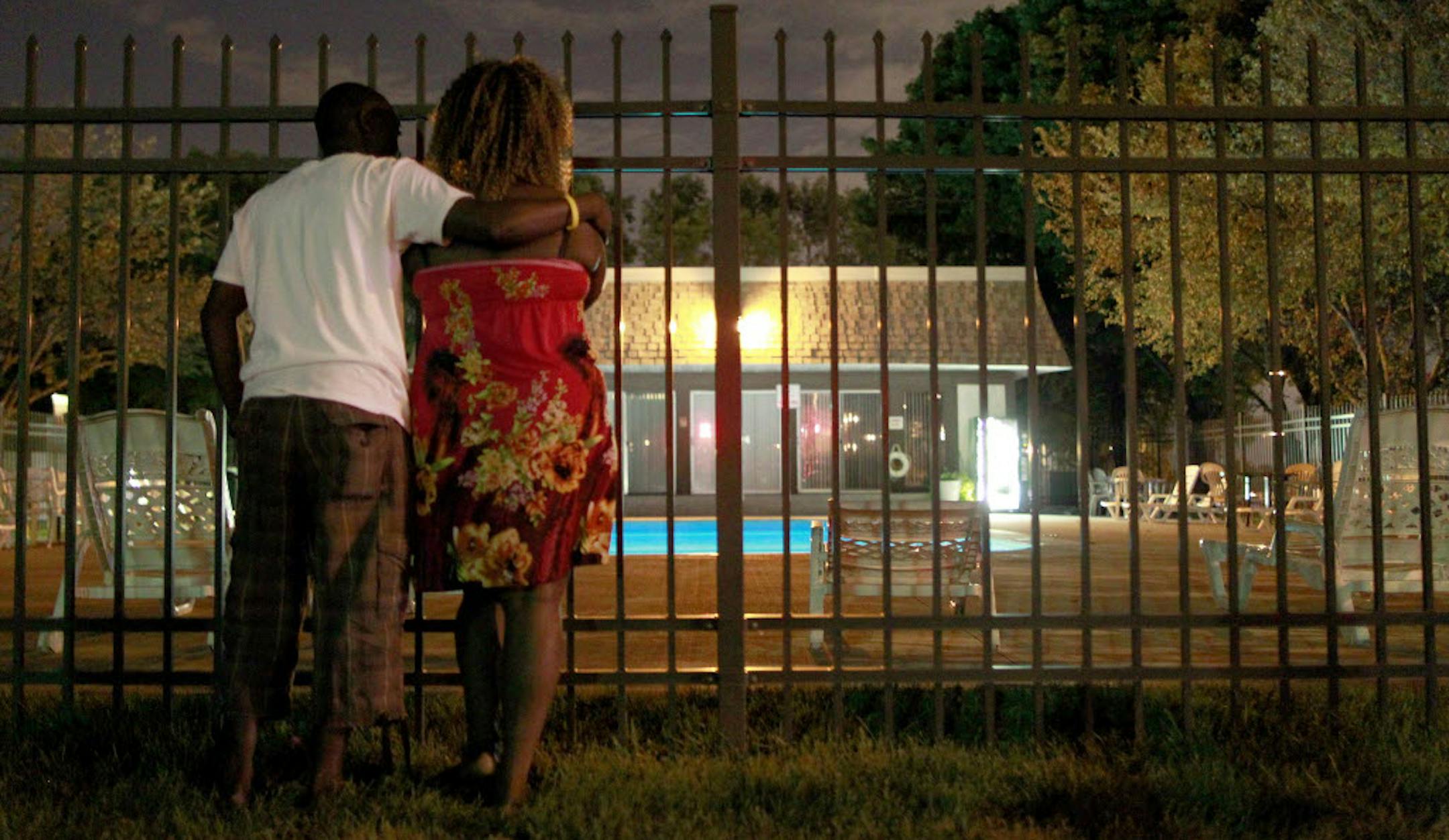 Samson Williams and Tonita Garnett stood at the fence by the pool where a 9-year-old girl and a 26-year-old man died just hours after the man jumped into a pool at a Plymouth apartment complex to try to save the girl from drowning. Both were friends of the 26-year old man.