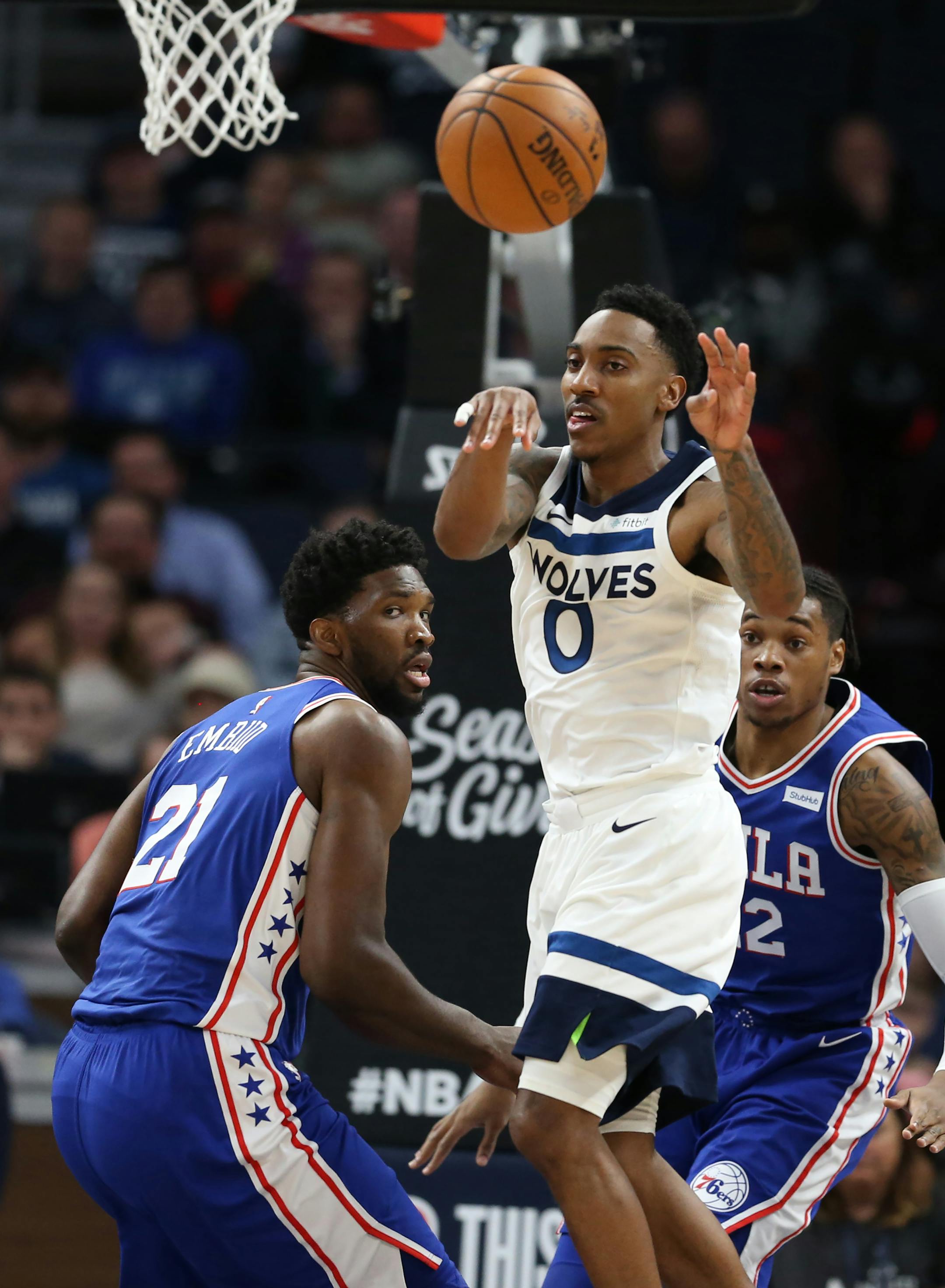 Minnesota Timberwolves guard Jeff Teague (0) passed the ball around Philadelphia 76ers center Joel Embiid (21) during NBA action at Target Center Tuesday December 12, 2017 in Minneapolis, MN.] The Minnesota Timberwolves hosted the Philadelphia 76ers at Target Center. JERRY HOLT � jerry.holt@startribune.com