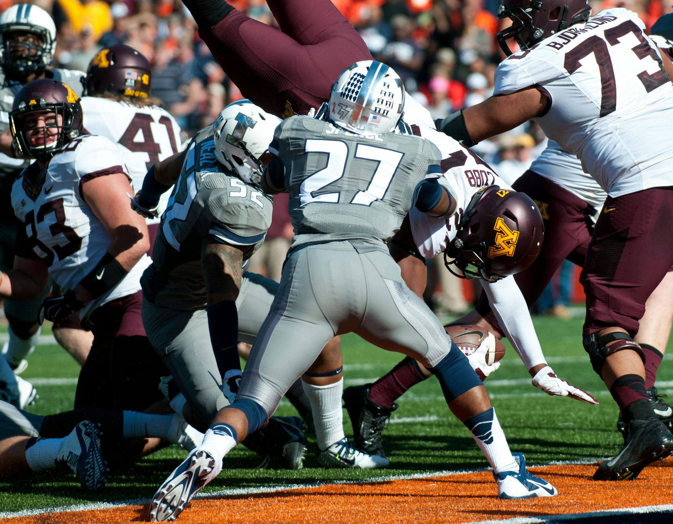 Minnesota running back David Cobb (27) scores a touchdown during the second half of an NCAA football game against Illinois, Saturday, Oct. 25, 2014, in Champaign, Ill. (AP Photo/Bradley Leeb)