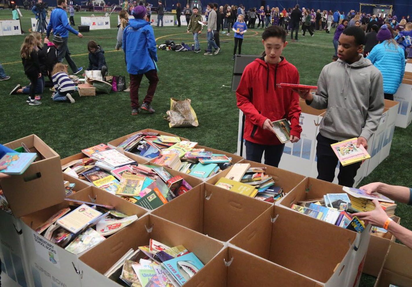 Tens of thousands of books, school supplies, sports equipments in the hands of underserved children in the greater Twin Cites area thanks to efforts of local students and the National Football League through a Super Bowl project called Super Kids-Super Sharing Thursday, Jan. 18, 2018, at the Braimar Field Dome in Edina, MN. Before the event had even ended 43,460 items had been collected by kids from various Minnesota school districts. Here, Zack Brown, right to left, and Kevin Song, 8th graders