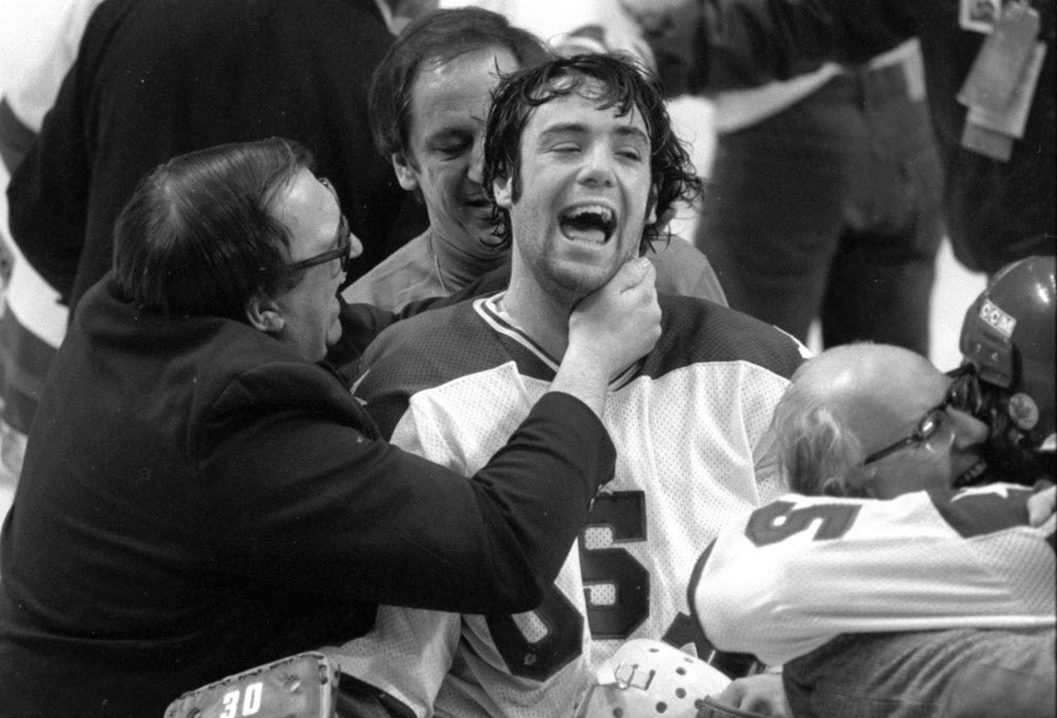 Lake Placid, New York, February 1980 - Miracle on Ice - Goalie Jim Craig is embraced by assistant coach Warren Strelow.