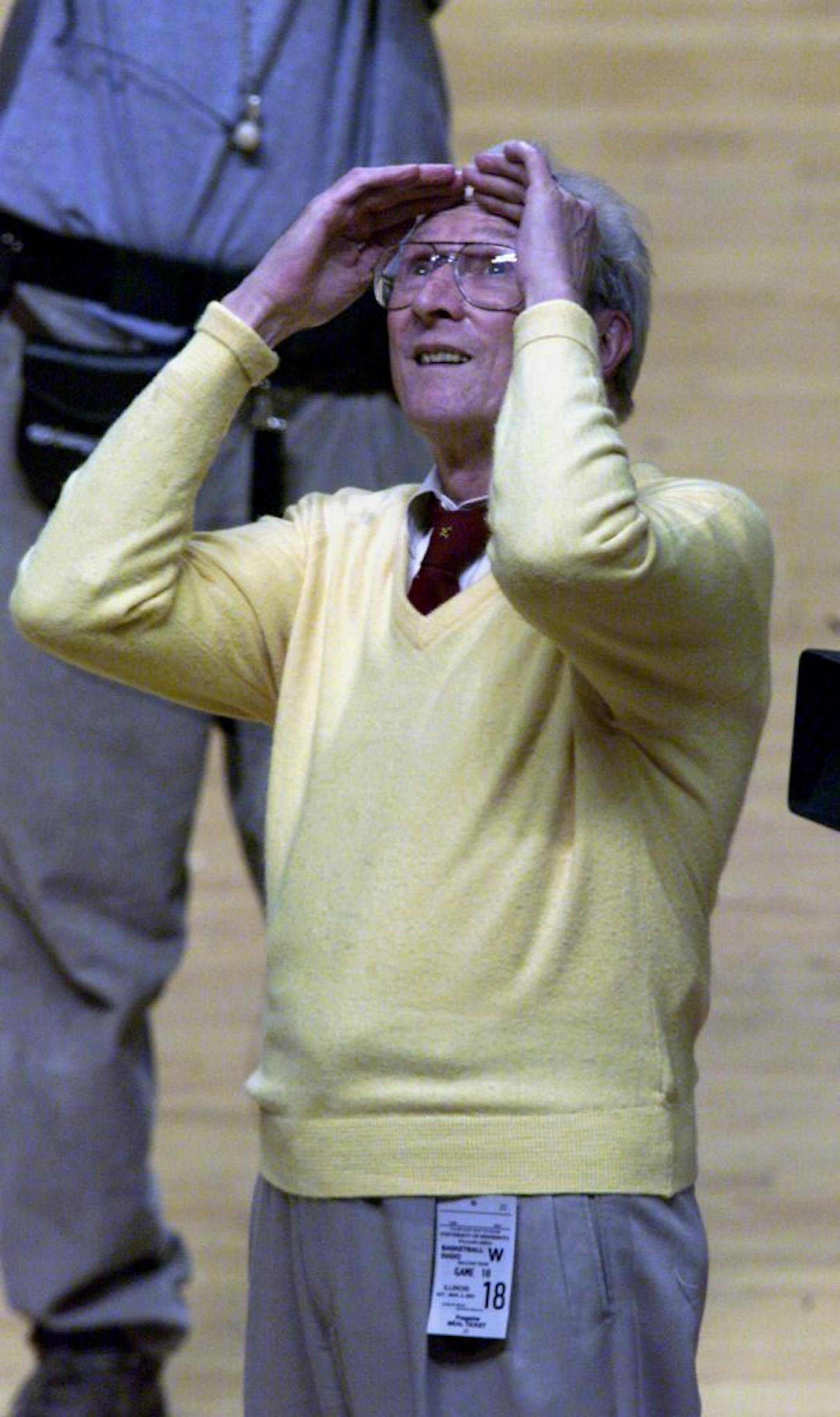 Ray Christensen, long-time Gopher radio broadcaster, peers to the rafters of Williams Arena for a banner he unfurled commemorating his service to the University - this during halftime festivities of the Illinois-Minnesota basketball game Sunday.