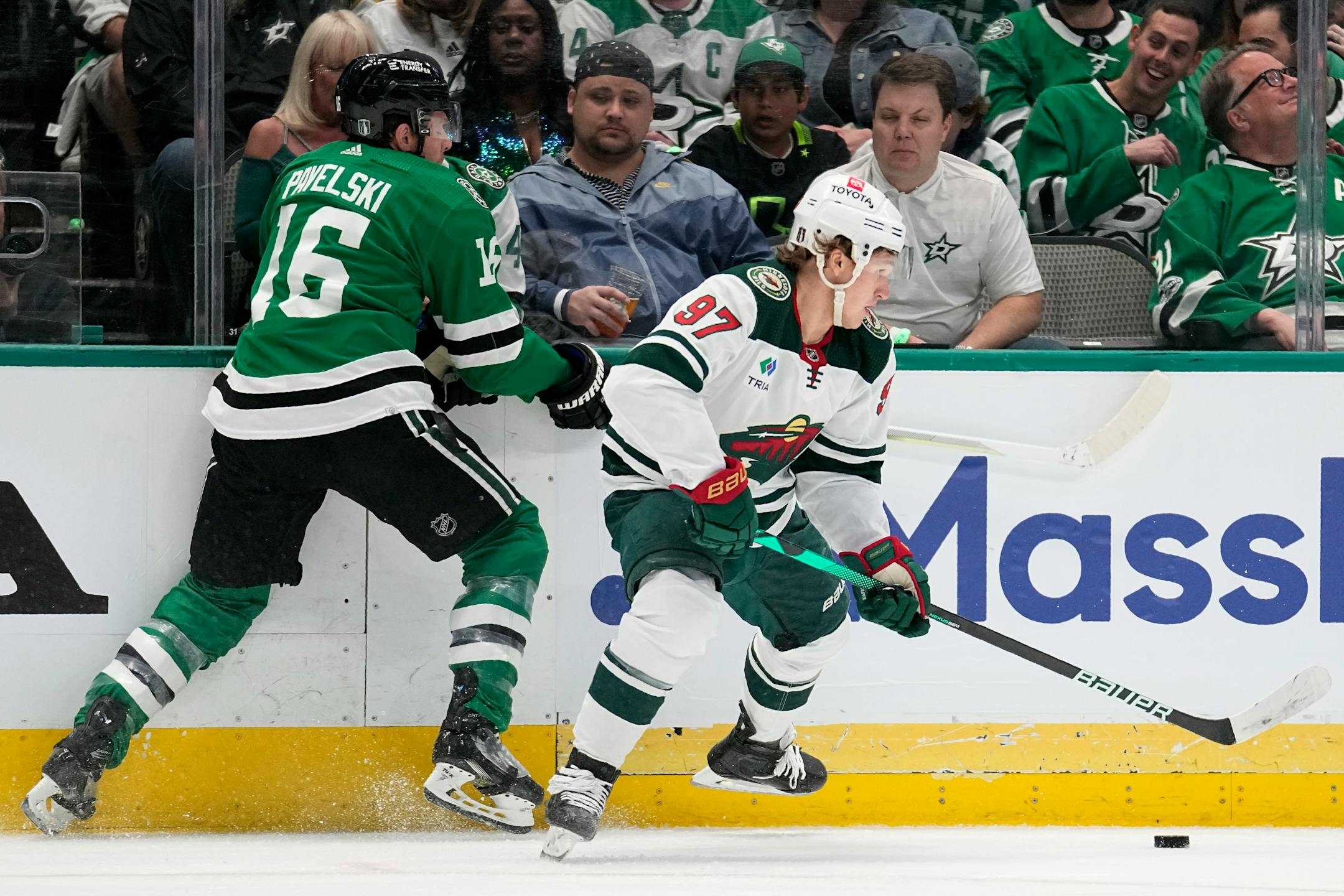 Dallas Stars center Joe Pavelski (16) and Minnesota Wild left wing Kirill Kaprizov (97) compete for control of the puck during the first period.