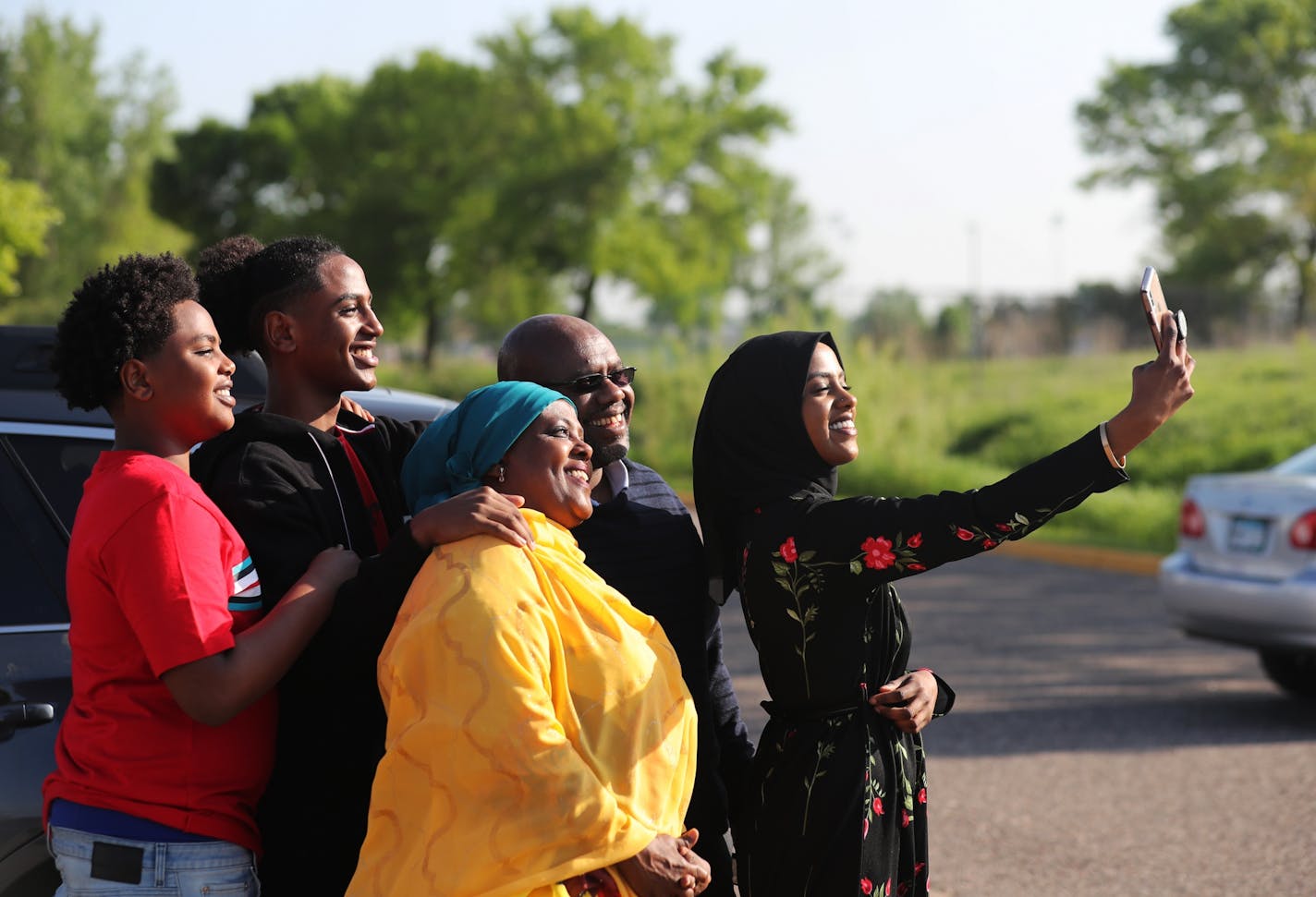 The Islamic Center of Minnesota held their Eid prayers at the National Sports Center Tuesday, June 4, 2019, in Blaine, MN. Here, Tajma Habib, 21, takes a selfie wither her parents, front to back, dad Abdi Osman, mom Kemer Yousuf, and brothers Mohamed Habib, 16, and Imran Habib, 14, in the parking lot following prayers. The family is from Maple Grove. More than one billion Muslims around the world will celebrate Eid al-Fitr this week, as the month-long Ramadan fast ends and the festivities begin.