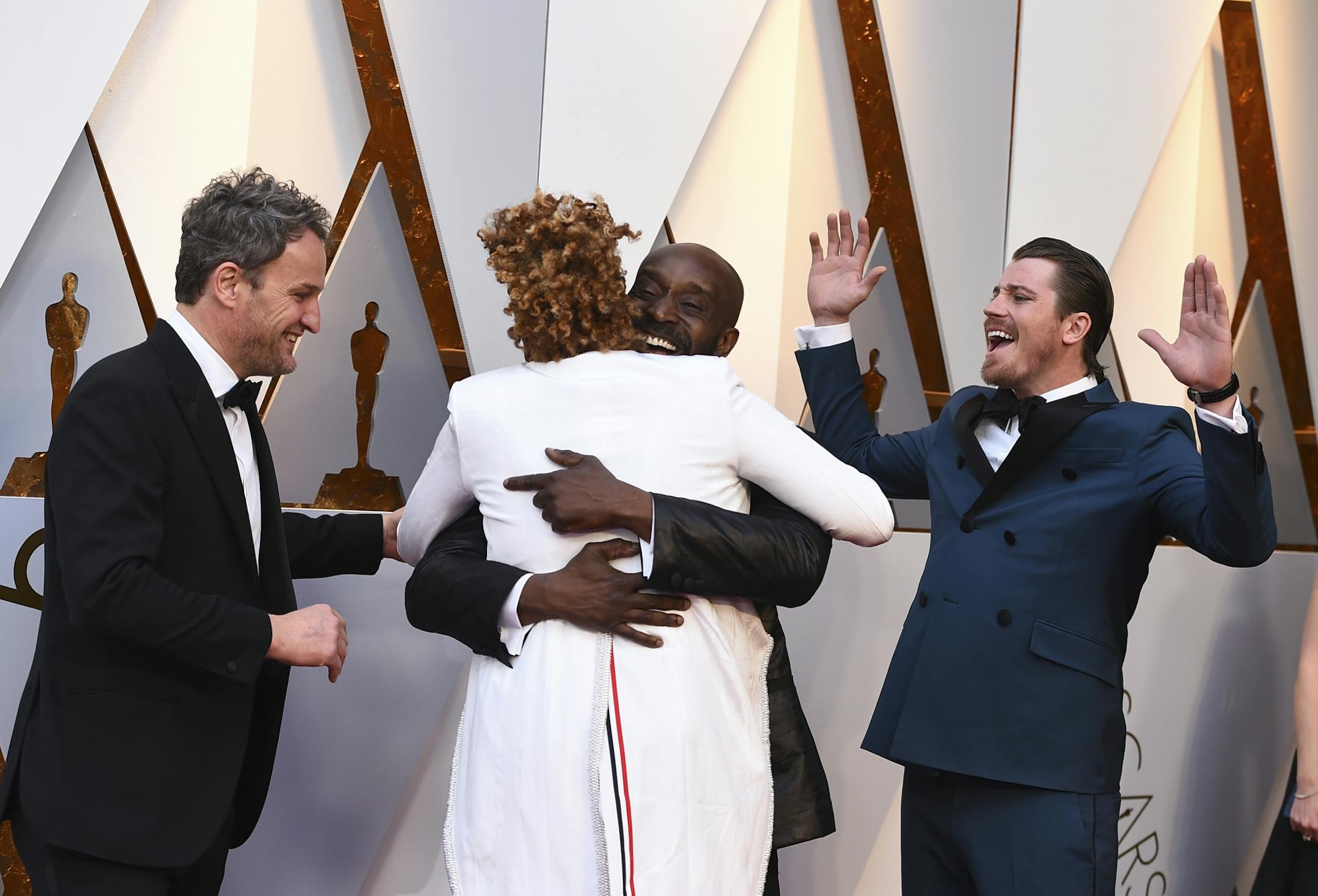 Jason Clarke, from left, Dee Rees, Rob Morgan, and Garrett Hedlund arrive at the Oscars on Sunday, March 4, 2018, at the Dolby Theatre in Los Angeles.
