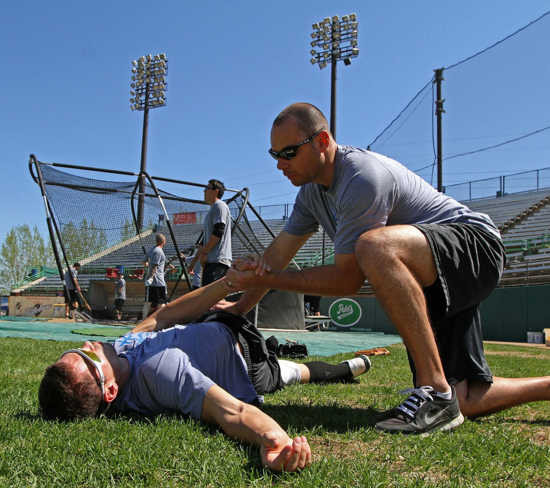 Saints outfielder Jordan Tripp — one of the seemingly few non-Minnesotans on the roster — stretched with the help of athletic trainer Jason Ellenbecker in preparation for Thursday’s season opener.