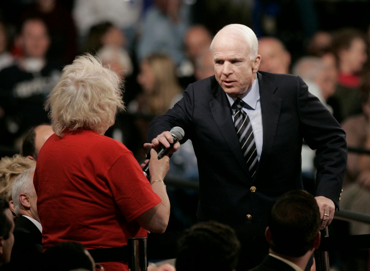 Republican presidential candidate Sen. John McCain, R-Ariz., right, takes back the microphone from Gayle Quinnell, who said she read about Sen. Barack Obama and "that he was an Arab," during a question and answer time at a town hall meeting at Lakeville South High School on Oct. 10, 2008.