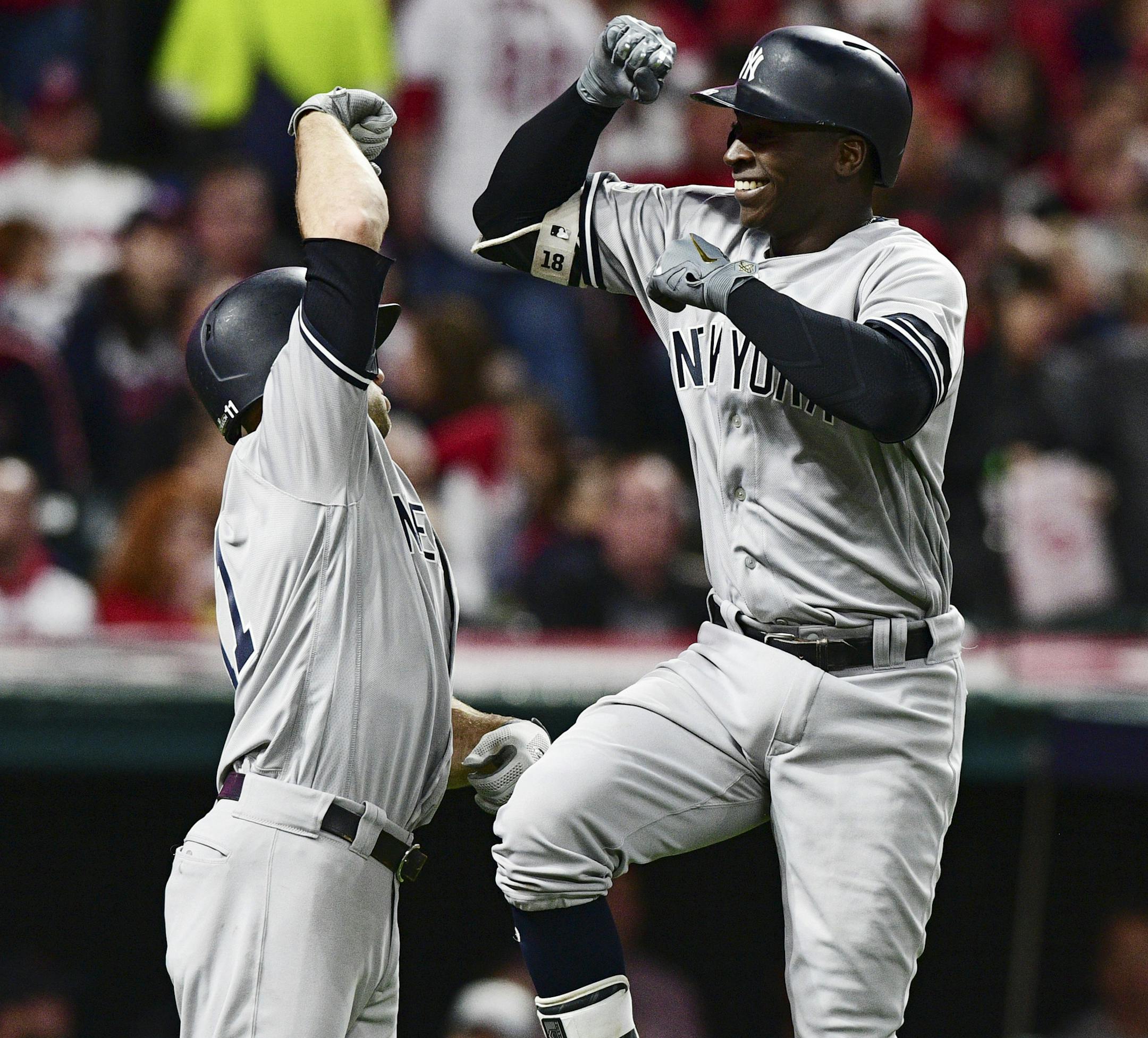 New York Yankees' Didi Gregorius, right, is congratulated by Brett Gardner after Gregorius hit a two-run home run off Cleveland Indians starting pitcher Corey Kluber during the third inning of Game 5 of a baseball American League Division Series, Wednesday, Oct. 11, 2017, in Cleveland. Gardner scored on the play. (AP Photo/David Dermer)