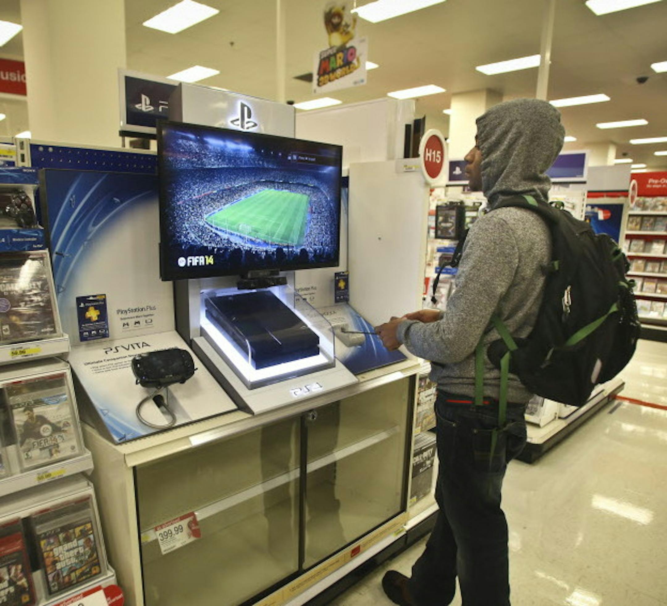 Chris Oden tried out a PS4, all of which were sold out, at Target in downtown Minneapolis, Minn., on Wednesday, December 4, 2013. With the introduction of Play Station 4 and XBox One, the first new video game consoles in 7 years, Best Buy and other retailers are hoping for a big lift to their holiday sales. ] RENEE JONES SCHNEIDER • reneejones@startribune.com