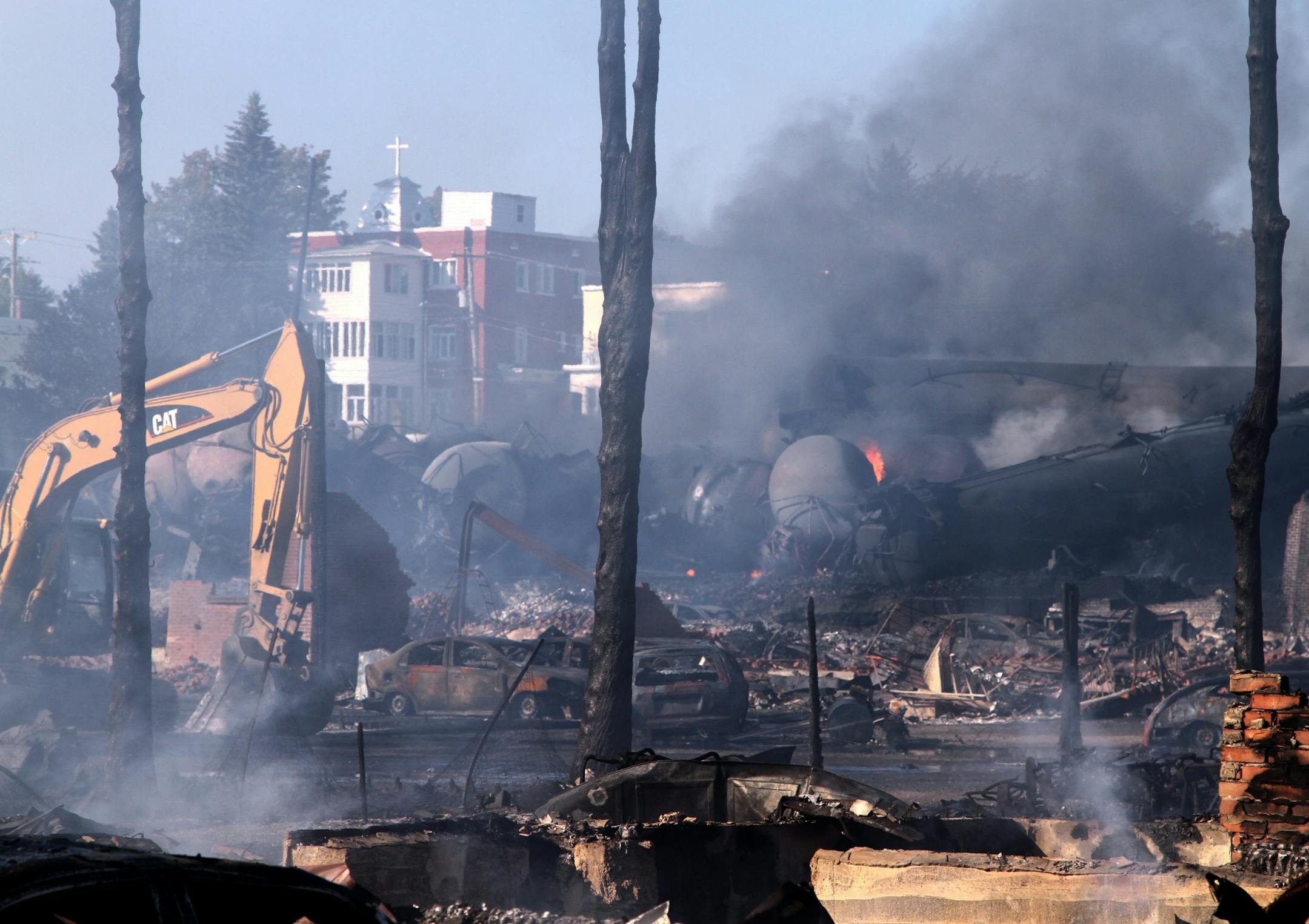 In a Monday, July 8, 2013 photo provided by Surete du Quebec via The Canadian Press, the downtown core lies in ruins in Lac-Megantic, Quebec, in a Surete du Quebec. Thirteen people are confirmed dead and forty more are listed as missing after a train derailed ignited tanker cars carrying crude oil.