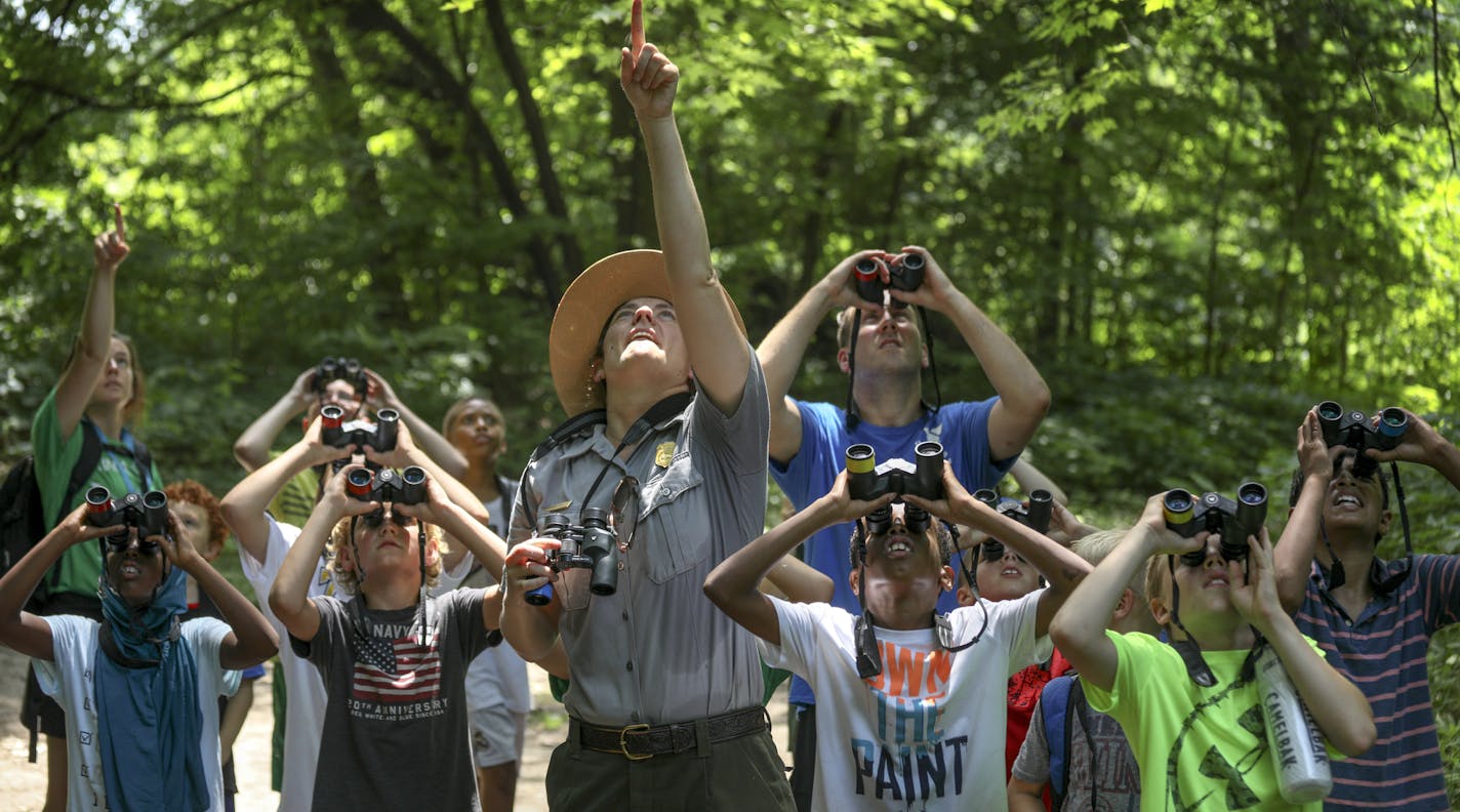 As part of their exposure to the great outdoors, kids used binoculars during a nature hike at Hidden Falls Regional Park.