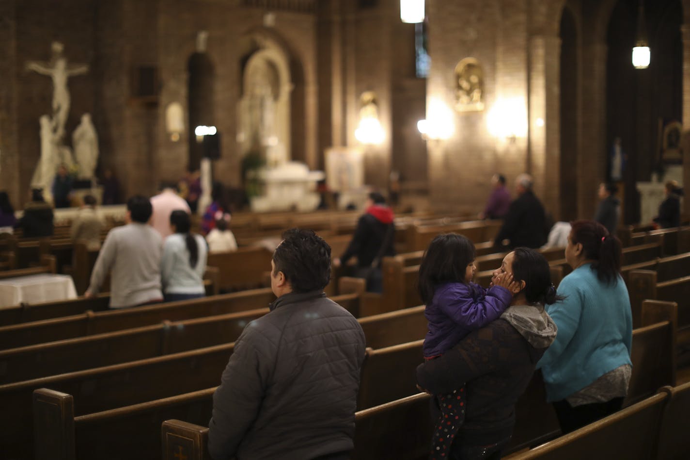 A family worshiped together at the Thursday night mass in Spanish at Church of the Incarnation/Sagrado Corazon de Jesus in Minneapolis. ] JEFF WHEELER &#xef; jeff.wheeler@startribune.com An undocumented congregant of the Church of the Incarnation/Sagrado Corazon de Jesus in Minneapolis was deported after being detained in an ICE sweep last week after nine years in the U.S. With Fr. Kevin McDonough presiding, the church held it's regular Thursday night Spanish mass to serve the Latino community o