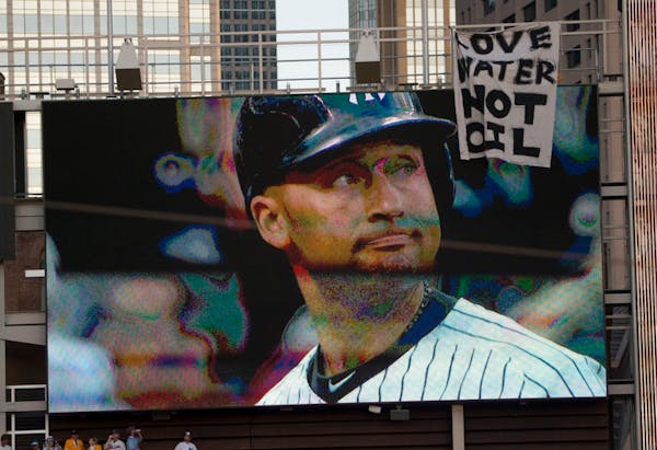 A large protest banner was hanging from the right field jumbo tron during the game.
