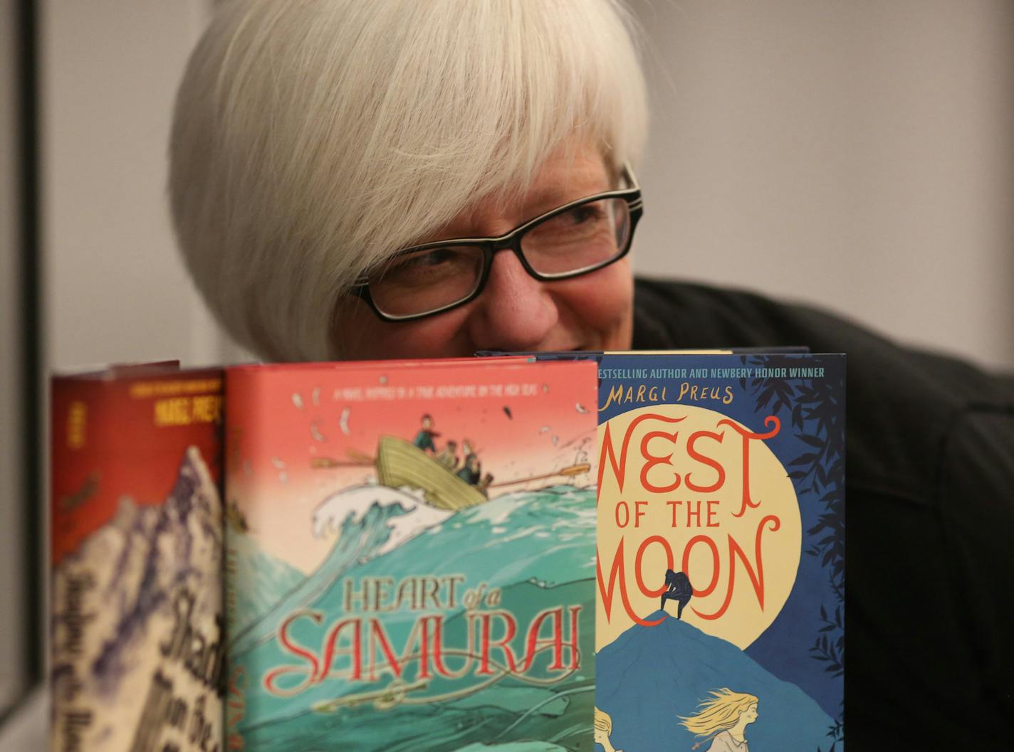 Author Margi Preus posed with some of her books after a speaking event. ] (KYNDELL HARKNESS/STAR TRIBUNE) kyndell.harkness@startribune.com During a speaking even for author Margi Preus at the Heritage Library in Lakeville, Min., Tuesday April 15, 2014.