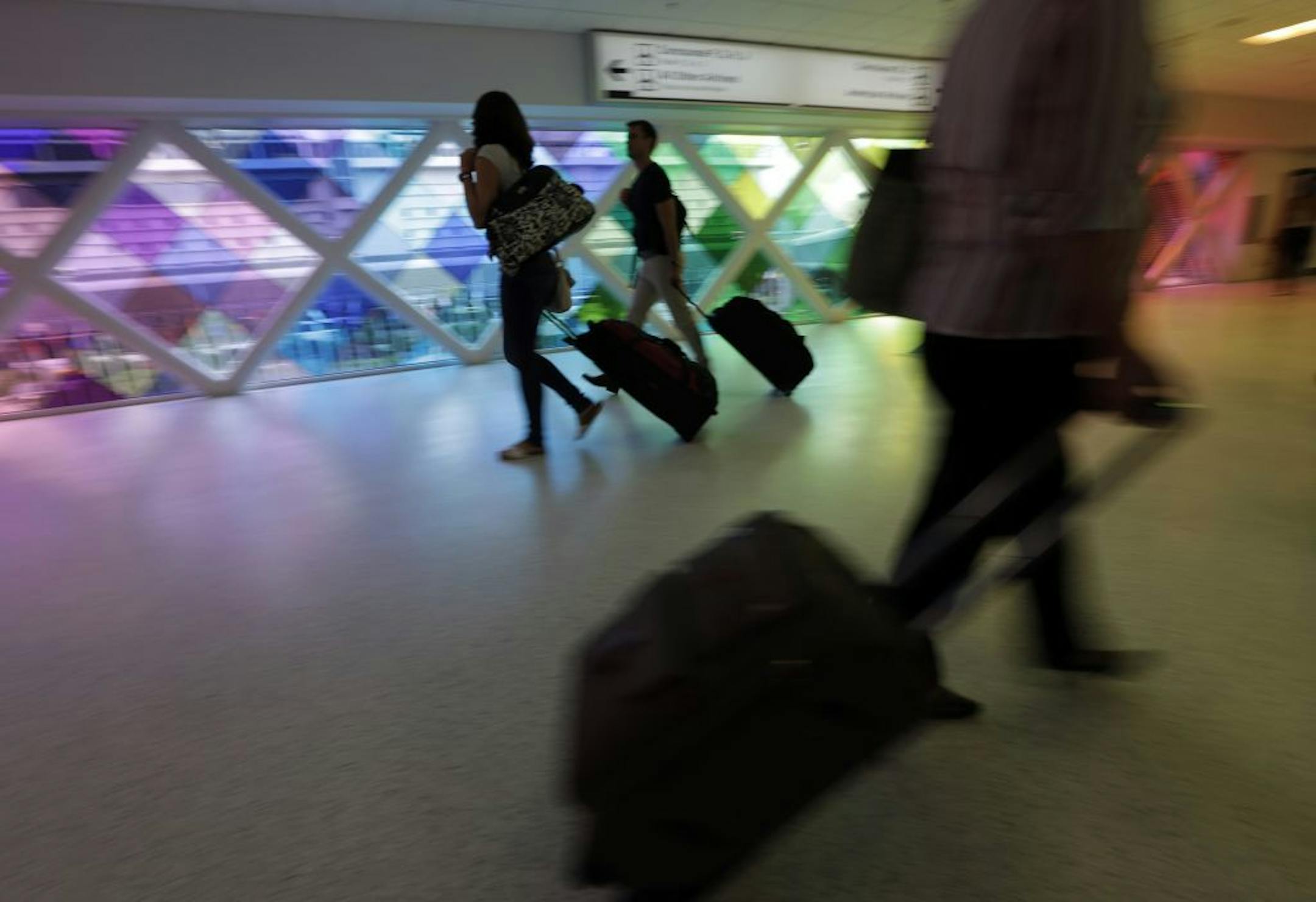 In this Thursday, Sept. 27, 2012 photo, passengers travel through an airport in Miami. Private researchers, who have analyzed federal data on airline performance, say in a report being released Monday, April 8, 2013, that consumer complaints to the Department of Transportation surged by one-fifth last year even though other measures such as on-time arrivals and mishandled baggage show airlines are doing a better job. "The way airlines have taken 130-seat airplanes and expanded them to 150 seats