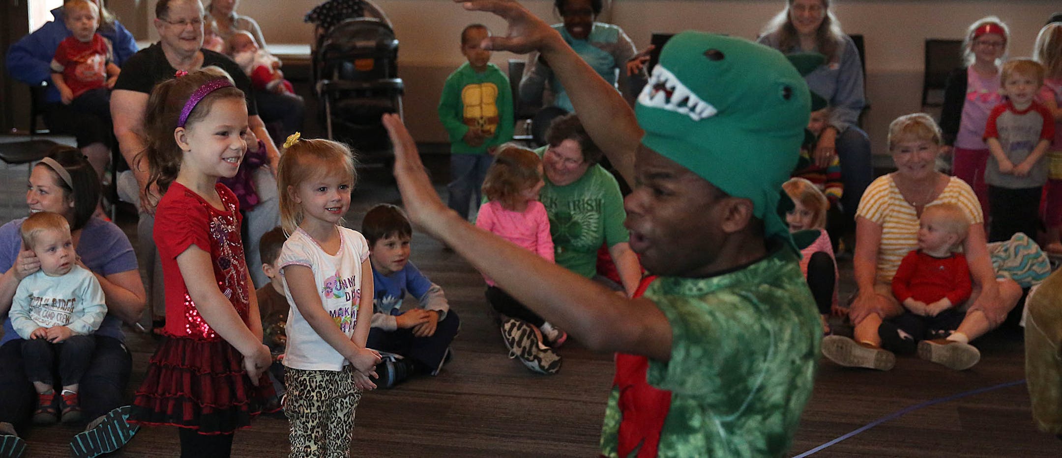 Actor Mahmoud Hakima played a dinosaur during the story-hour. ] JIM GEHRZ ï james.gehrz@startribune.com / Inver Grove Heights, MN / April 16, 2015 /10:30 AM - BACKGROUND INFORMATION: Home to job hunting resources, educational programs and wall-to-wall free entertainment, libraries were the place to be during the recession. But as the economy recovers and eBook use increases people are taking fewer trips to their library. Visits to metro area libraries dropped by more than 10 percent from 20