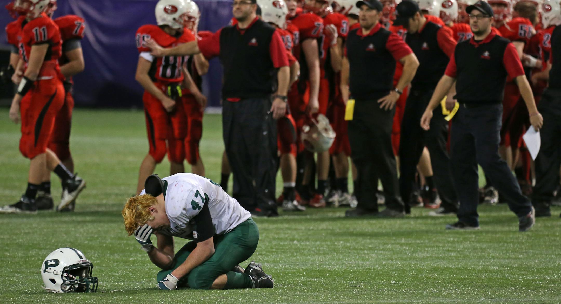 Minnesota State High School Prepbowl, Semifinals, Metrodome, 11/16/13. 1A St. Croix Lutheran vs. Proctor (left to right) Proctor's Andrew Kiminki slumped to the turf in dejection after his team lost to St. Croix Lutheran, on a field goal with seconds to go in the game.] Bruce Bisping/Star Tribune bbisping@startribune.com Andrew Kiminki/roster.