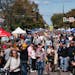 Hundreds of people walk past vendors during an October 2023 Open Streets event on Lyndale Avenue S. in Minneapolis.