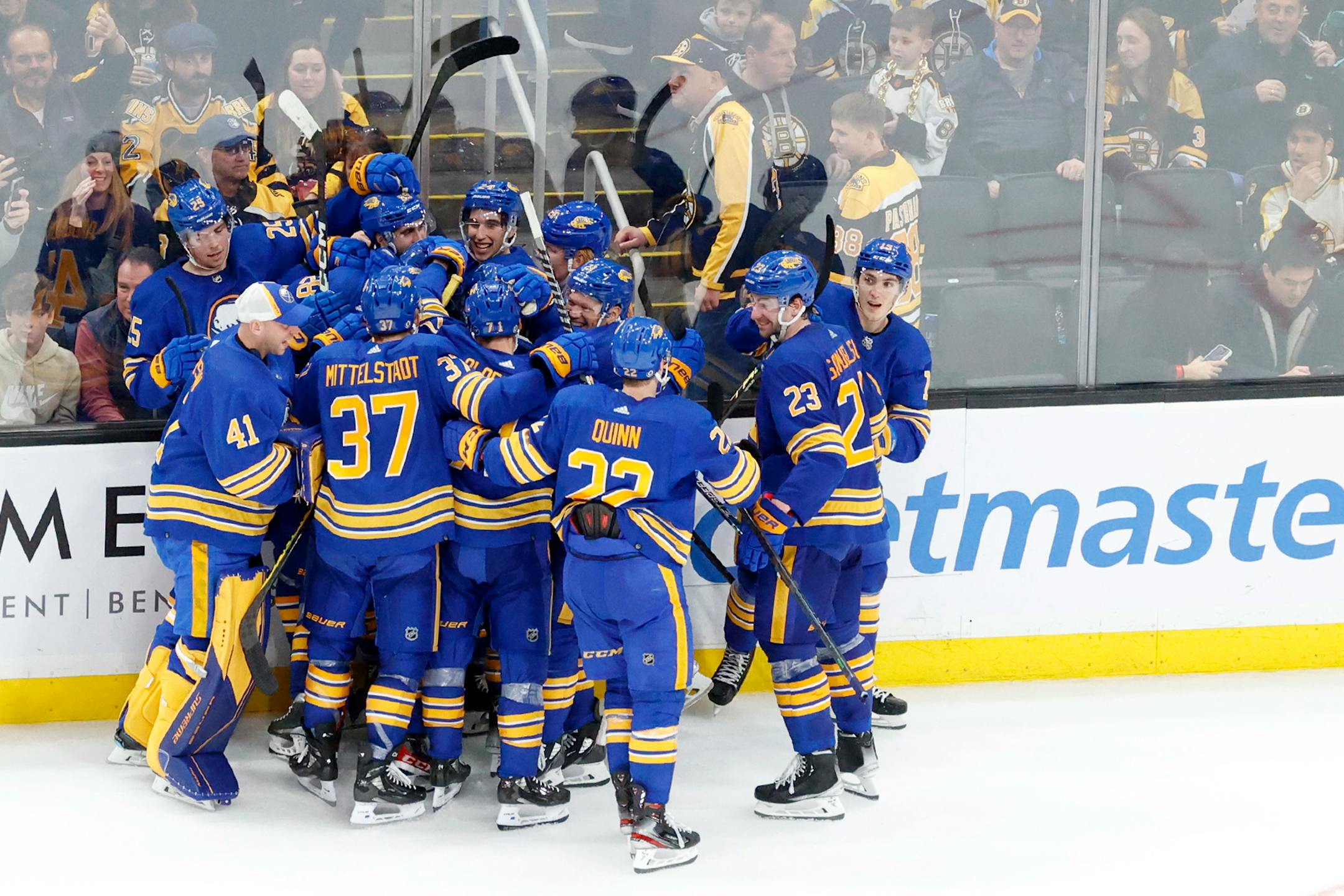 Buffalo Sabres players celebrate after scoring the game-winning goal during the overtime period of an NHL hockey game against the Boston Bruins, Saturday, Dec. 31, 2022, in Boston. (AP Photo/Mary Schwalm)