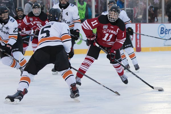 Centennial (in red) battled against Moorhead in a 2018 Hockey Day Minnesota game last January at an outdoor rink built on St. Cloud's Lake George.