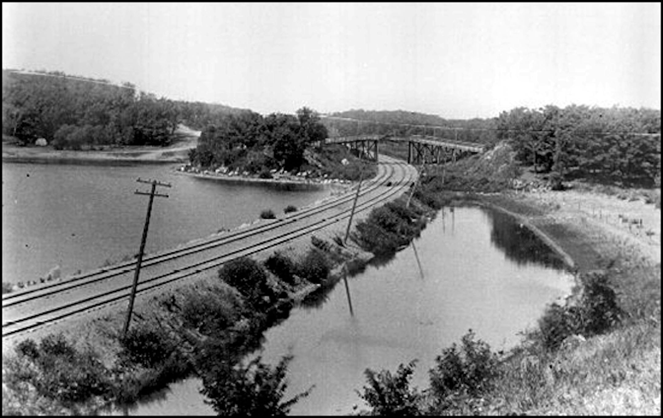 Great Northern tracks on north side of Cedar Lake, looking west. Between Cedar Lake and Brownie Lake near Cedar Lake Blvd Mpls MN Photographer: Wallof, William G.