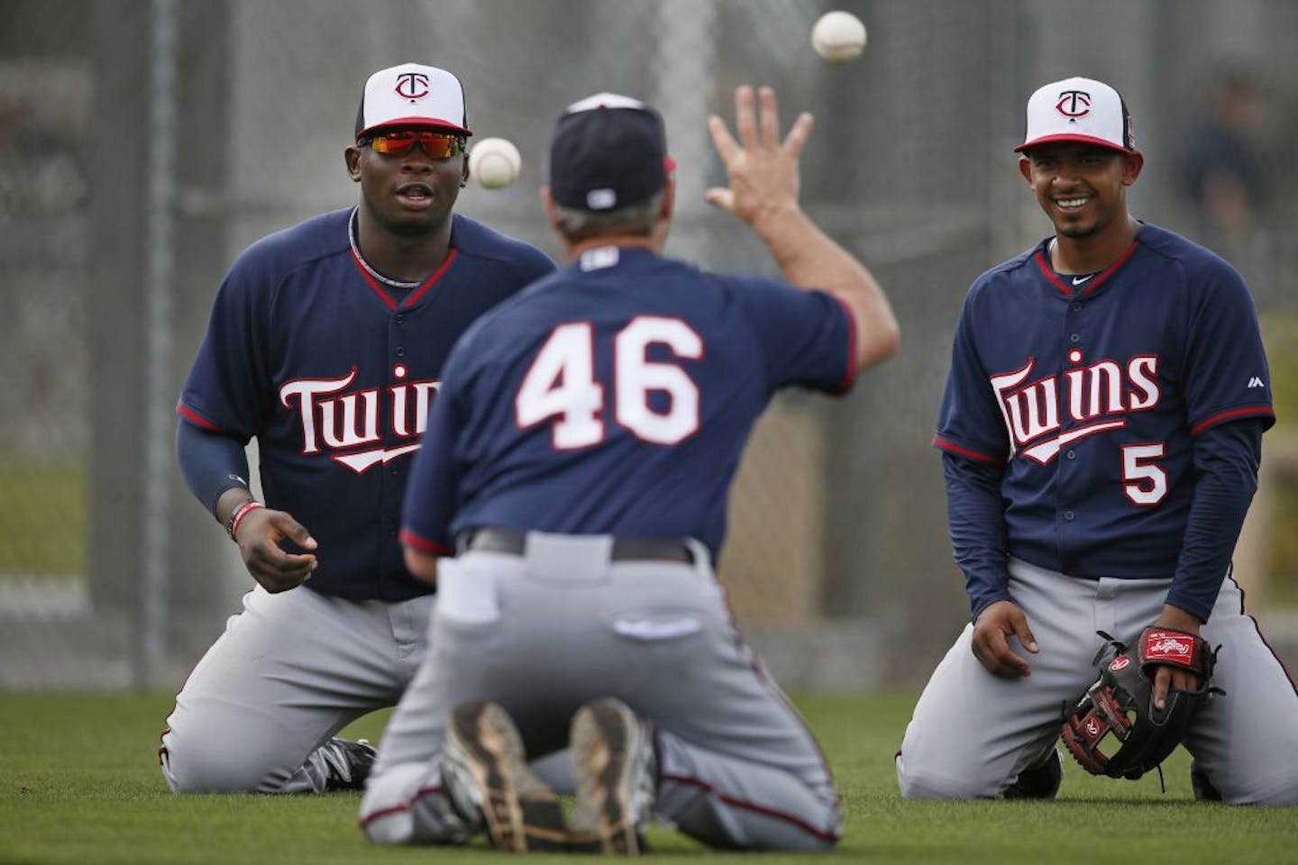 Joe Vavra worked with Miguel Sano left and Eduardo Escobar during spring training in 2014.