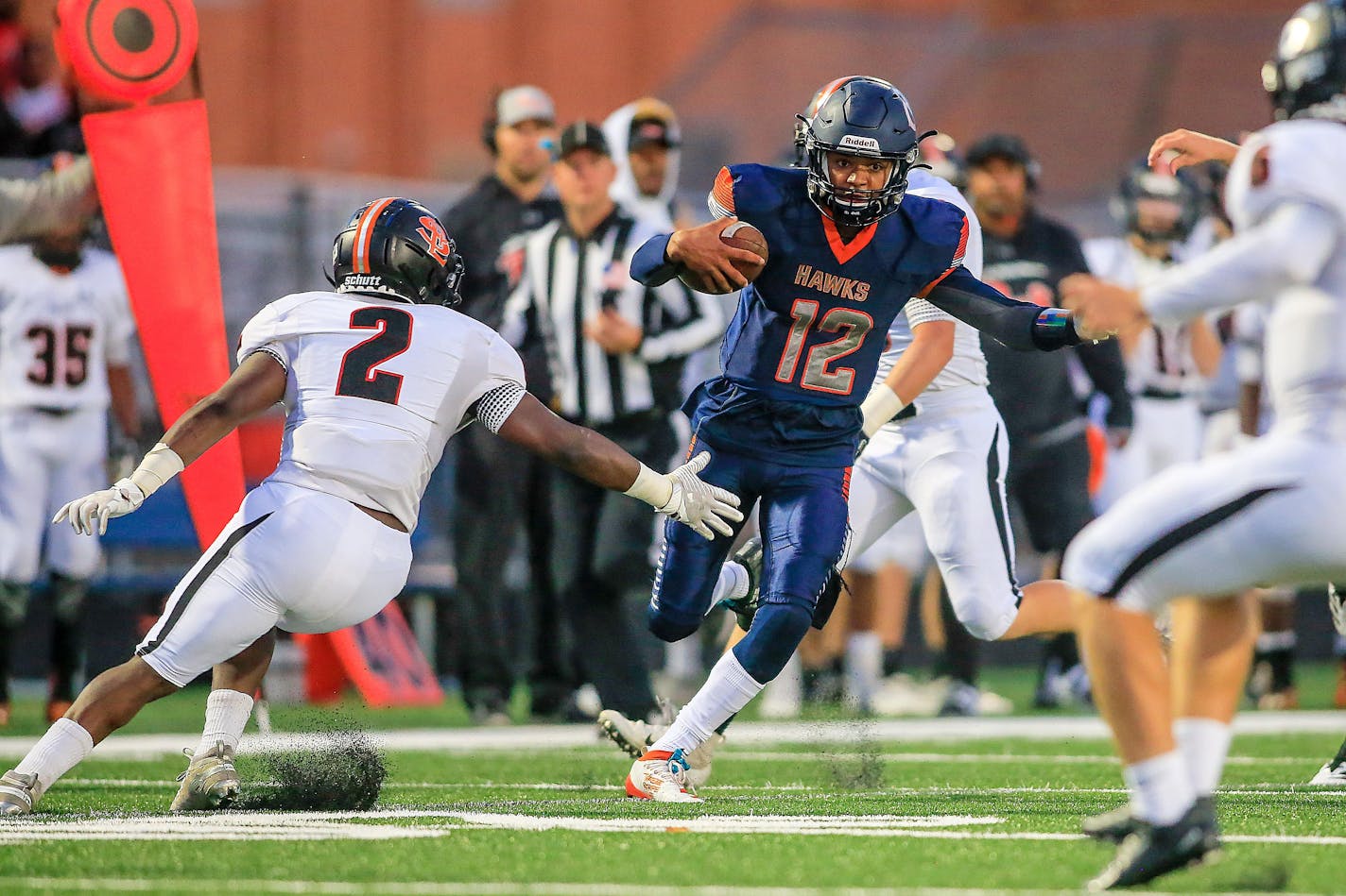 Robbinsdale Cooper quarterback Joseph Russell (12) made his way through the St. Louis Park defense for a 52-yard touchdown run in the second quarter. Cooper held a 21-13 lead at the half. Photo by Mark Hvidsten, SportsEngine