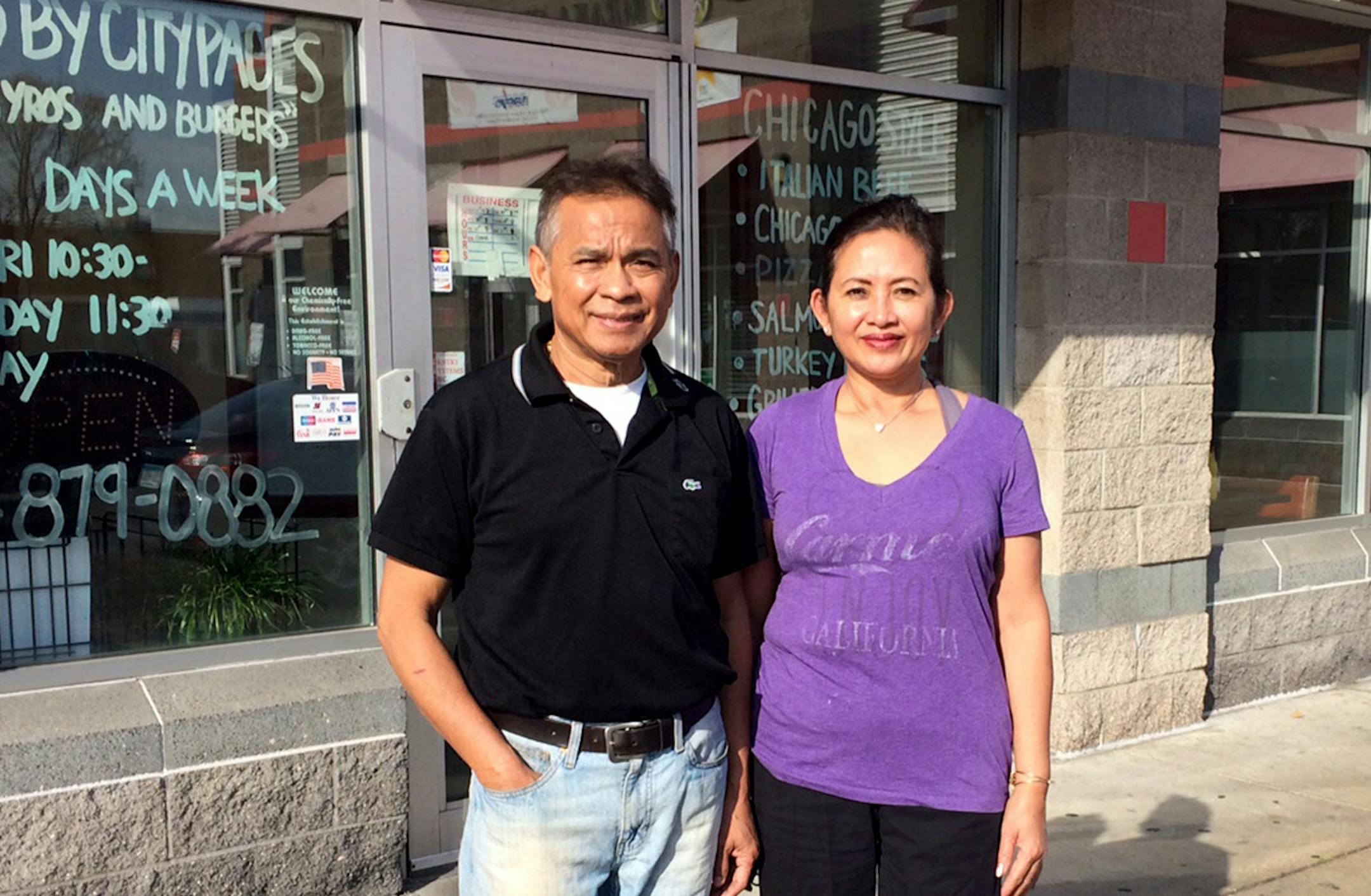 Sophal and Tevy Nhep in front of The Best Steak & Gyros House they have owned at 1914 Chicago Av. S. since 1992.