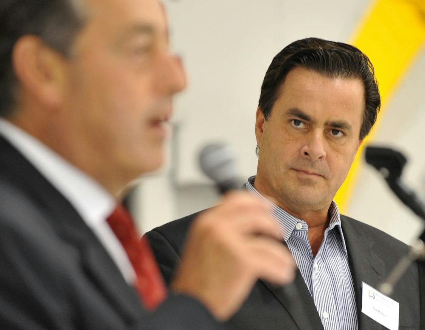 FILE -- In this 2008 photo, Tom Petters is introduced by President of Petters Aviation Jay Salmen, Petters then spoke to employees and invited guests at an open house for Petters Aviation at Minneapolis-St. Paul International Airport.