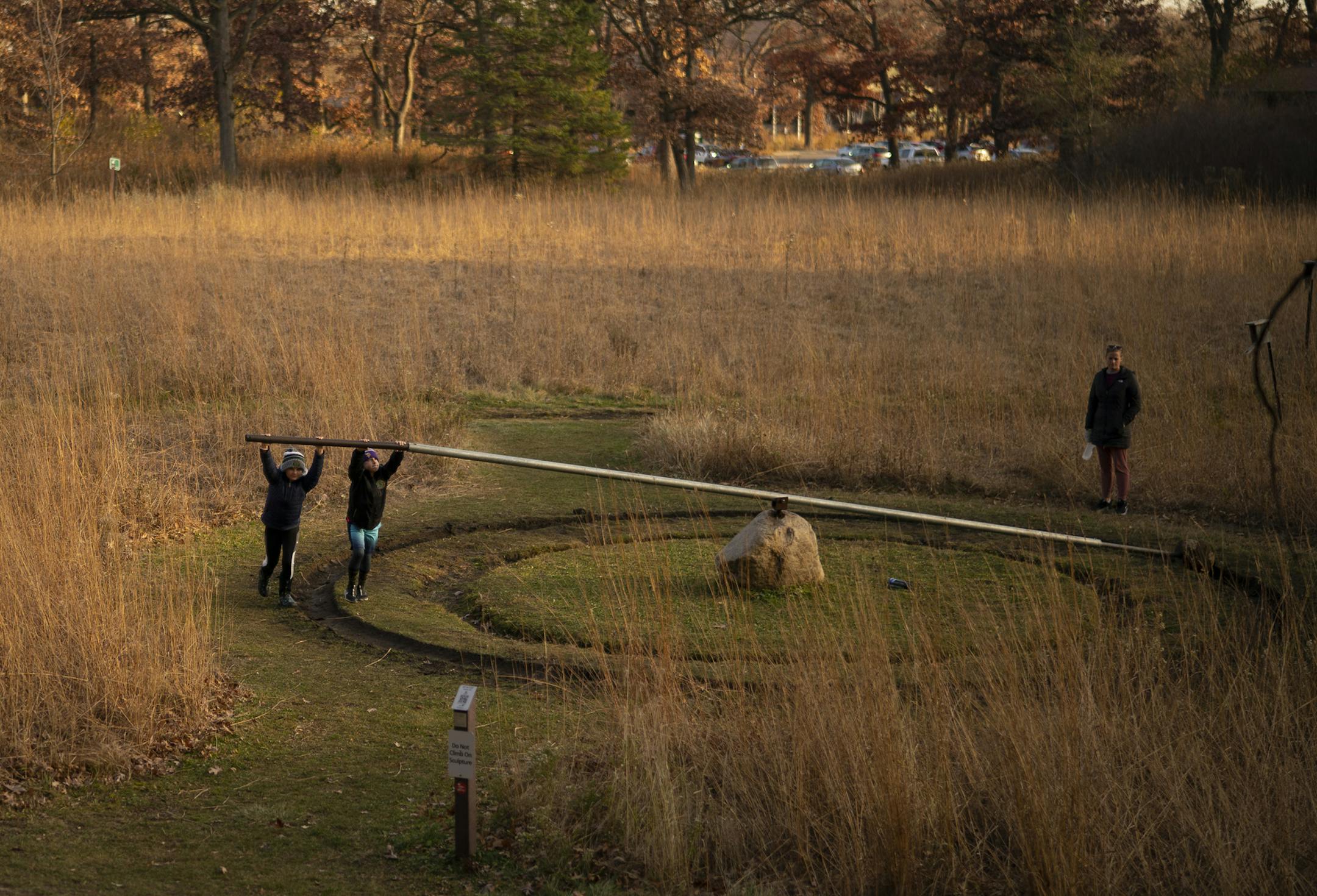 Jenna Zumwalt watched as her kids, Audrey, 9, left, and Chase, 8, operated the Erosion Machine, a 2014 interactive sculpture by Trygve Nordberg at Silverwood Park. ] JEFF WHEELER • jeff.wheeler@startribune.com Silverwood Park in St. Anthony was popular with walkers and others enjoying the warm temperatures late Monday afternoon, November 2, 2020.