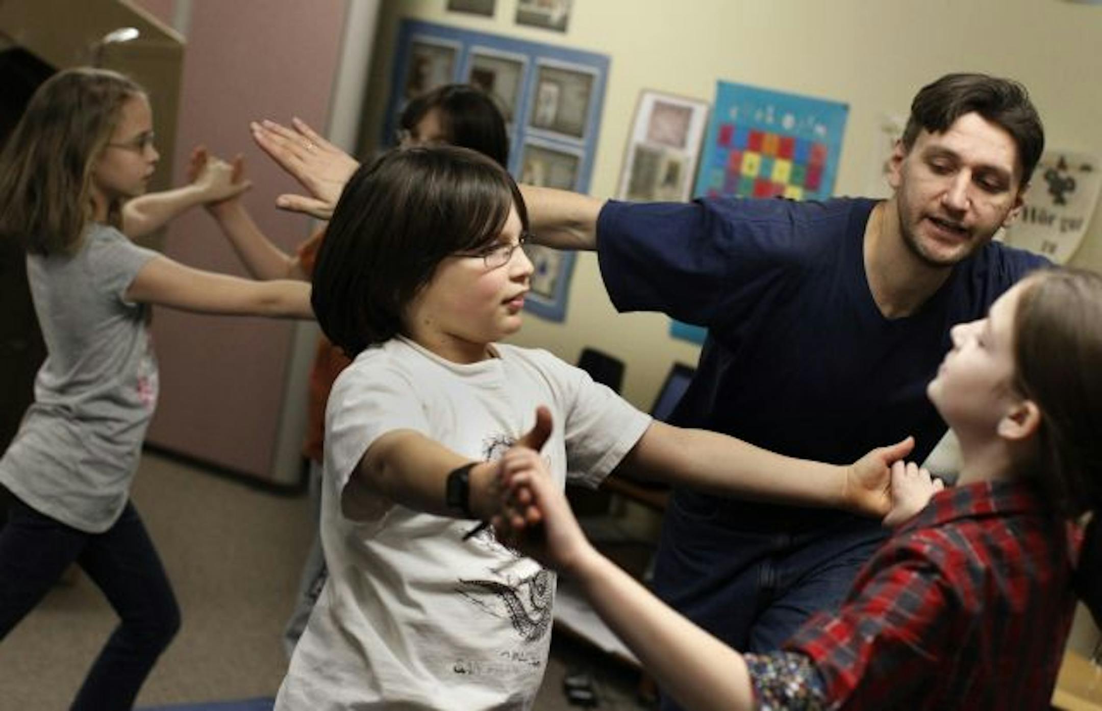 Valentin Solakhau the performing Arts teacher at the Twin Cities German Immersion School in St. Paul helped fifth graders Nele Roth left, Matu Mueller and Ingrid Sampson with their tango moves. Valentin is a native of Belarus is preparing the k-6 students for their Friday night performance of Carnival of Cultures, a celebration of song and dance from around the world . The event will take place on Friday 11; at St. Thomas More Catholic Community and school starting at 6pm. Valentin has a masters