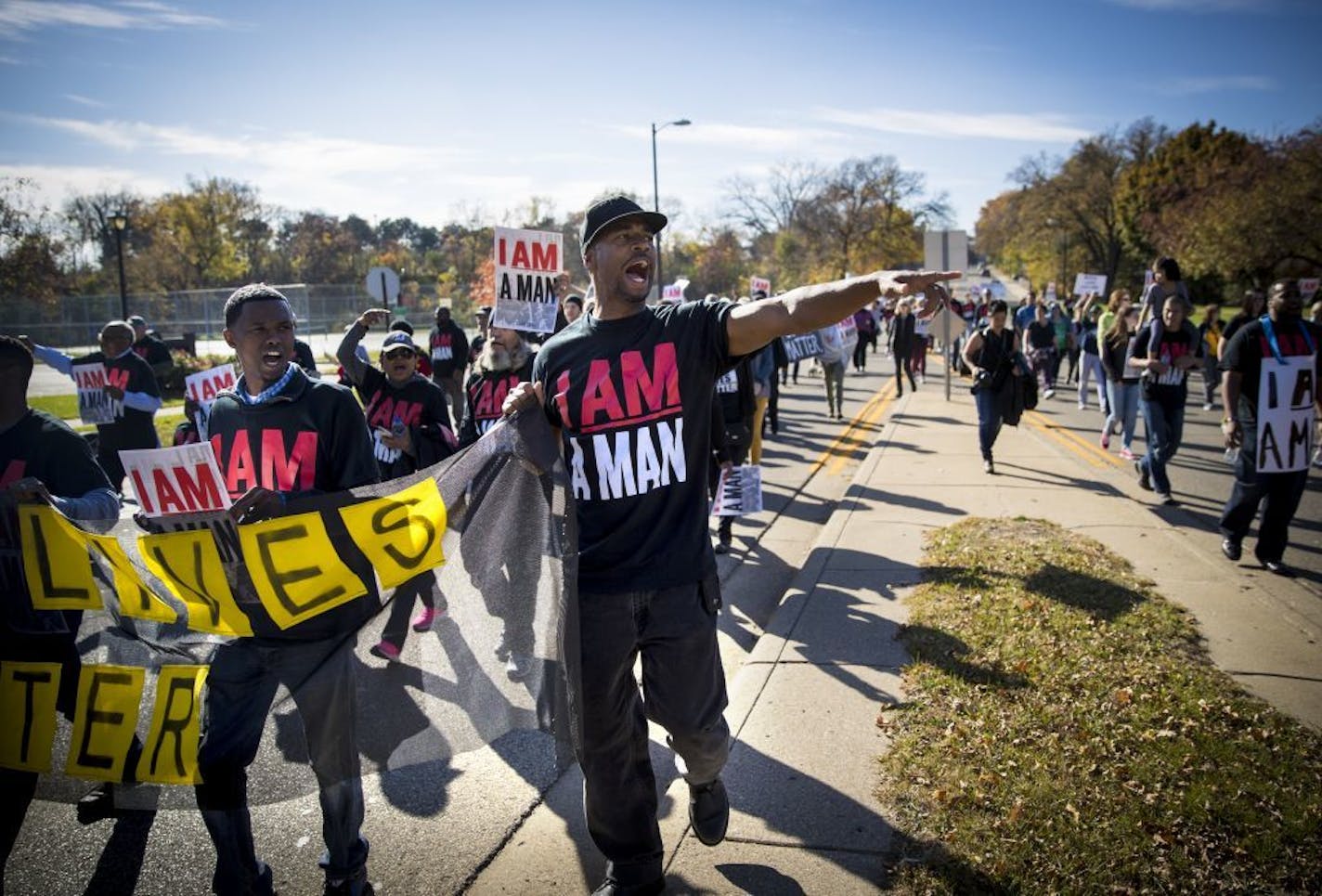 Protesters marched down the middle of the street during a protest march on 50th Street on Saturday, October 22, 2016, in Edina, Minn.