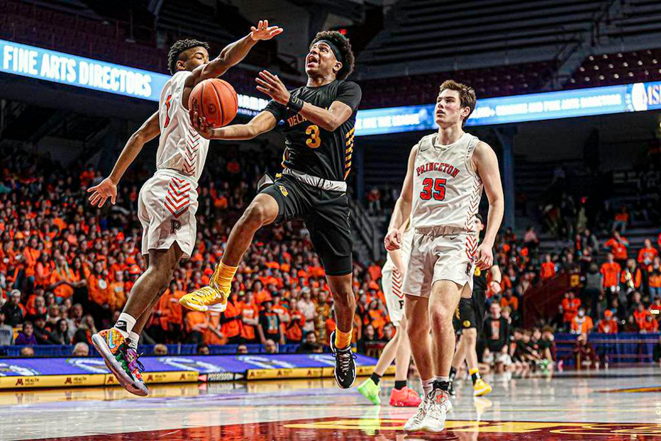 DeLaSalle's Nasir Whitlock (3) drives for a layup in the second half against Princeton's Cooper Nowak. Whitlock had 28 points, six assists and five rebounds in the Islanders' victory. Class 3A semifinals, DeLaSalle vs. Princeton, at Williams Arena, 3-23-22. Photo by Mark Hvidsten, SportsEngine