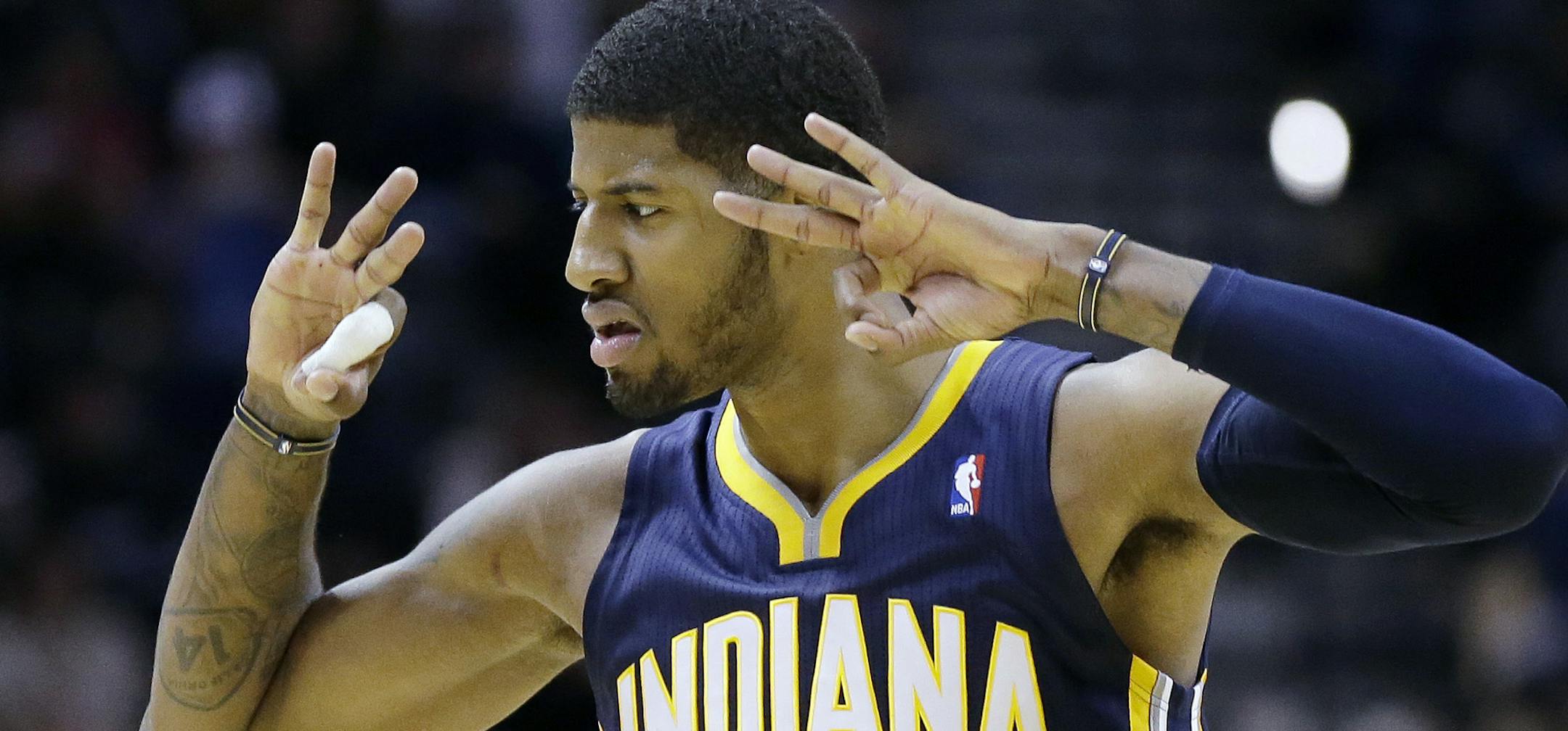 Indiana Pacers' Paul George signals towards the San Antonio Spurs bench after he scored during the second half of an NBA basketball game Saturday, Dec. 7, 2013, in San Antonio. (AP Photo/Eric Gay)