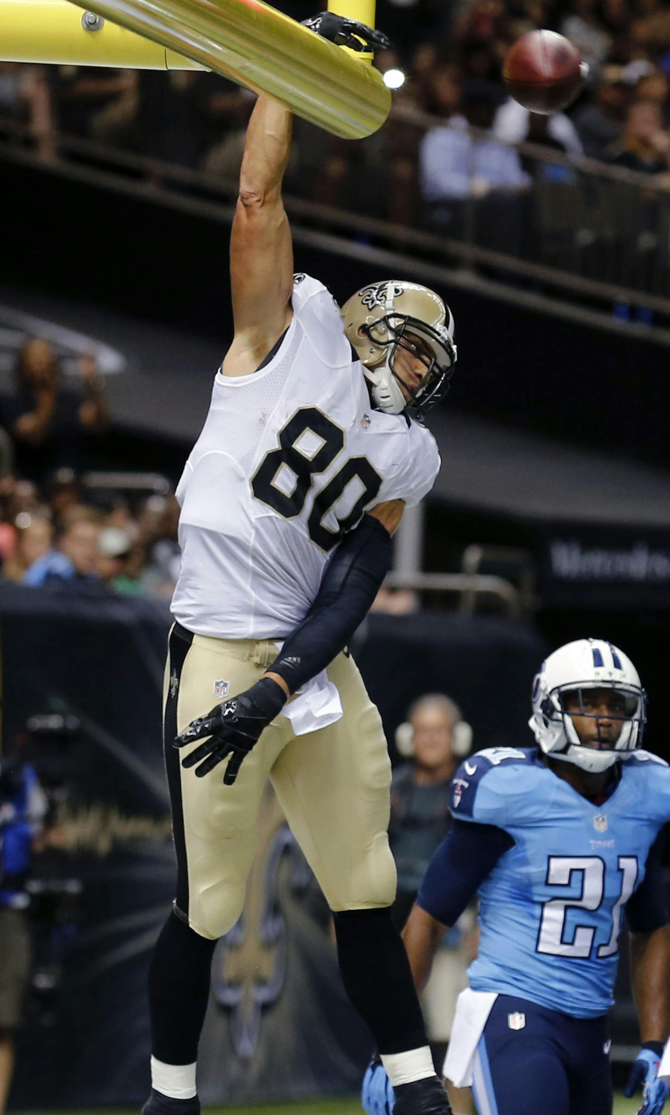 New Orleans Saints tight end Jimmy Graham (80) slam dunks over the goal post after scoring on a touchdown reception in the first half of a NFL preseason football game against the Tennessee Titans in New Orleans, Friday, Aug. 15, 2014. (AP Photo/Bill Haber) ORG XMIT: LAGH121