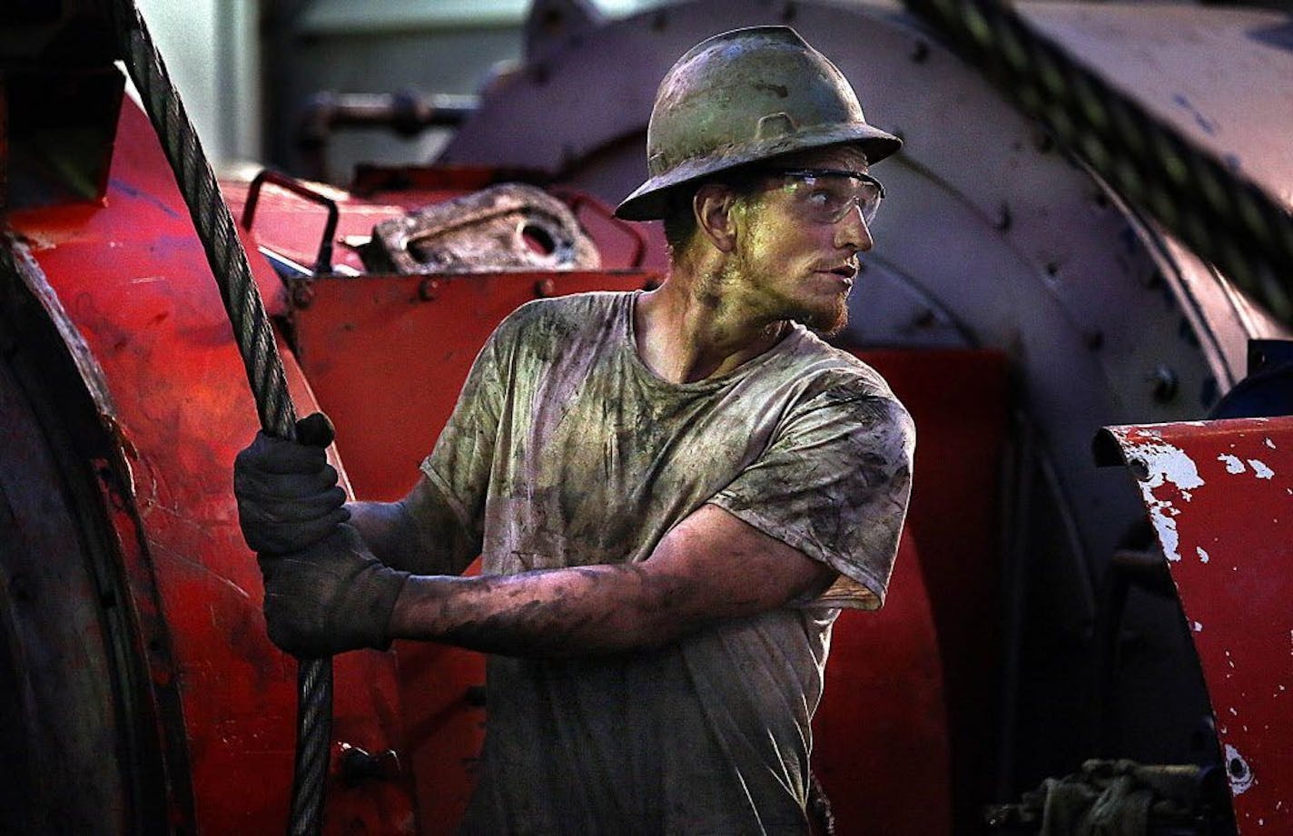 Floor hand Ray Gerrish worked to make repairs on a drilling rig as the sun rose near the site outside Watford City in this Oct. 23, 2013 file photo.