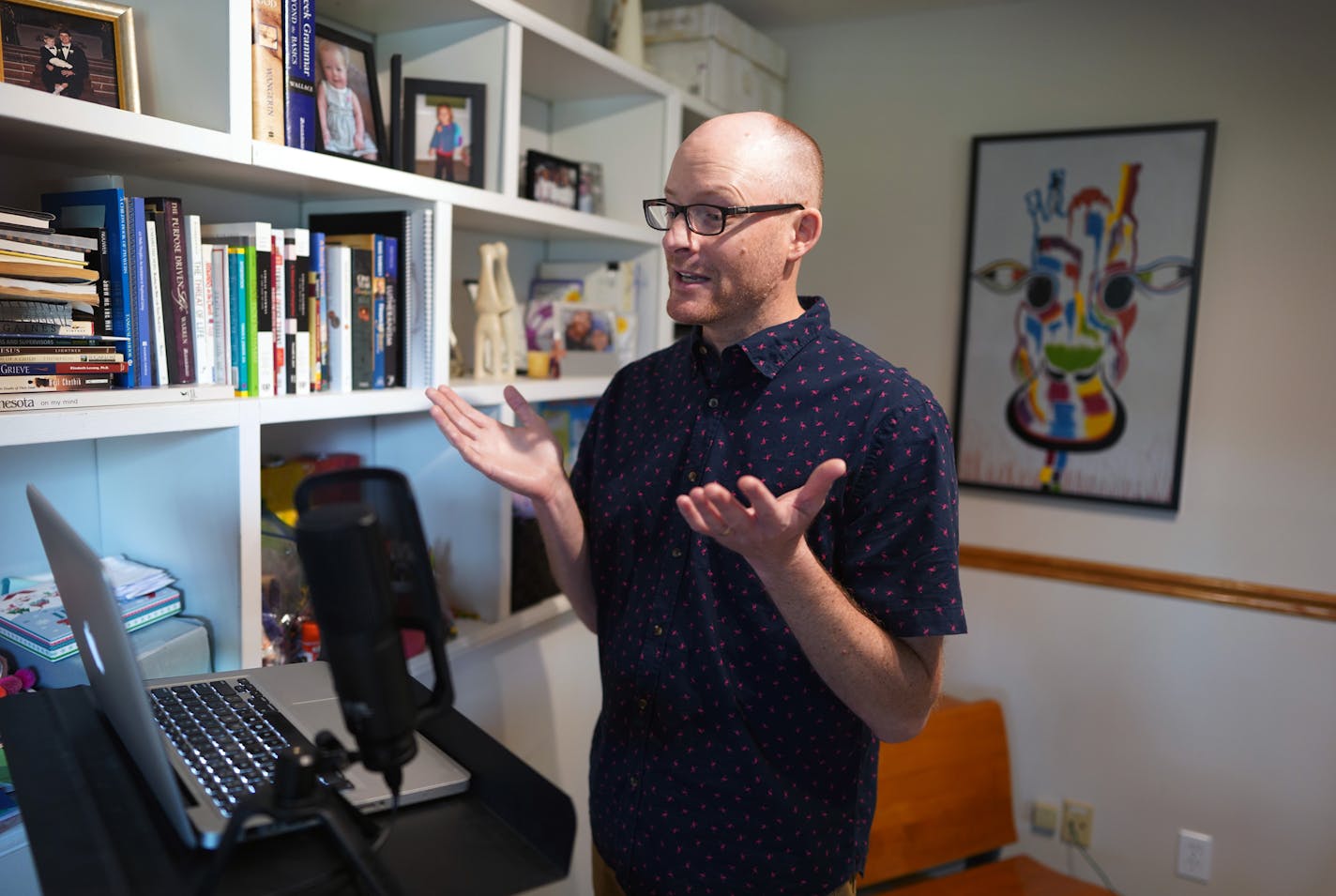 In his basement home office, Pastor Brandon Newton video taped himself delivering a reading for Sunday's service. It will be spliced into a worship service pieced together this week.