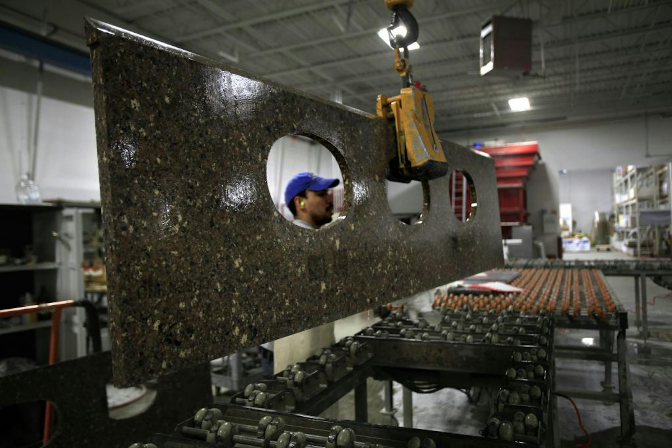 Granite is cut and sanded for a very shiny finish at Minnesota Tile and Stone in Minnetonka, MN. The producton area is located next to the new show room and can be seen by customers. Minnesota Tile and Stone is opening a 40,000 square foot studio for customers to select materials for home remodels.