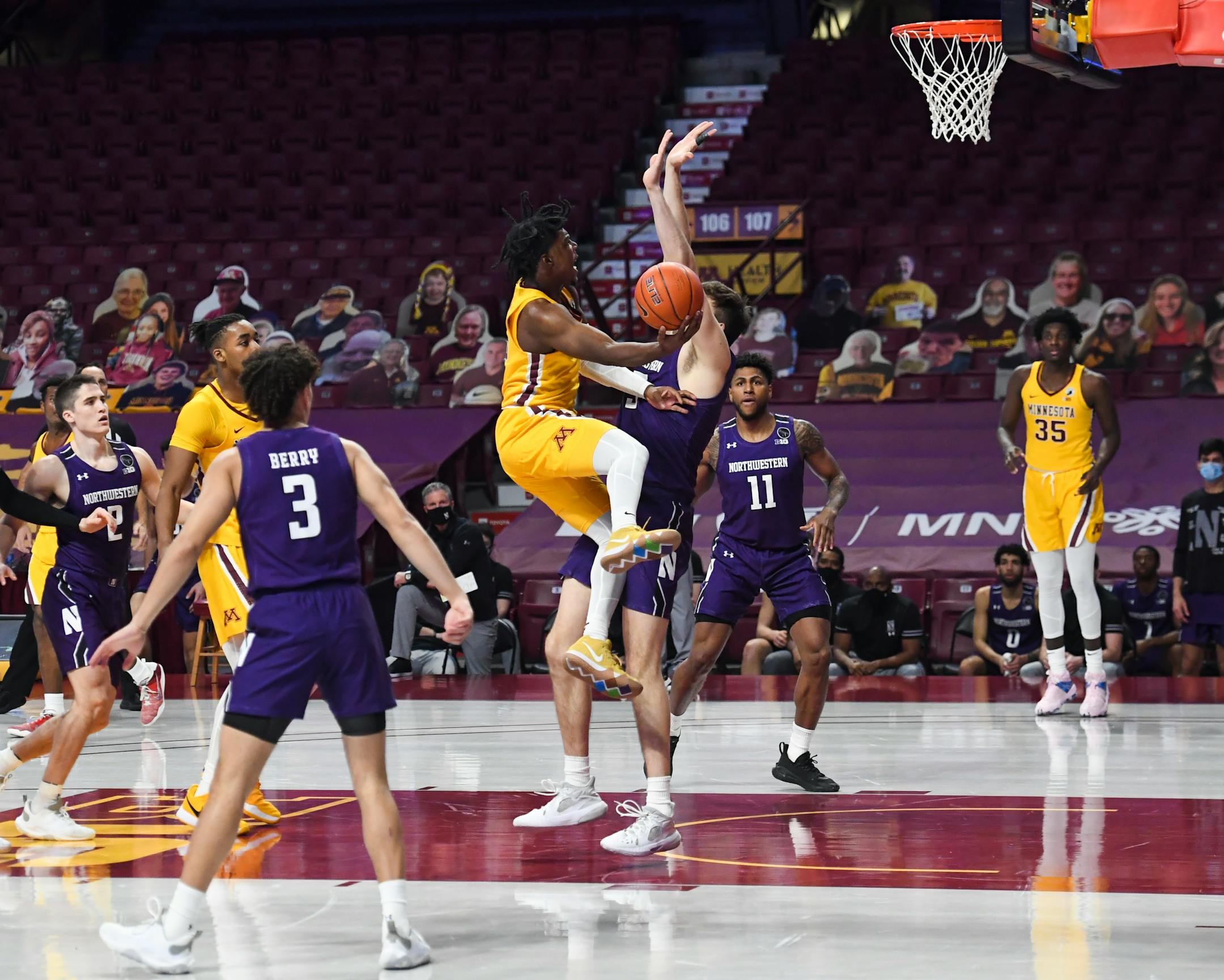 Minnesota Gophers guard Marcus Carr (5) was fouled by Northwestern Wildcats center Ryan Young (15) as he attempted a layup, missing the shot but hitting both free throws.