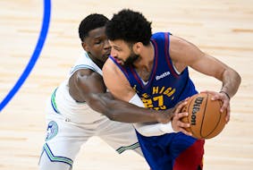 Timberwolves guard Anthony Edwards (5) reaches in to defend Nuggets guard Jamal Murray in the second quarter of Game 6 at Target Center.