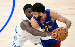Timberwolves guard Anthony Edwards (5) reaches in to defend Nuggets guard Jamal Murray in the second quarter of Game 6 at Target Center.