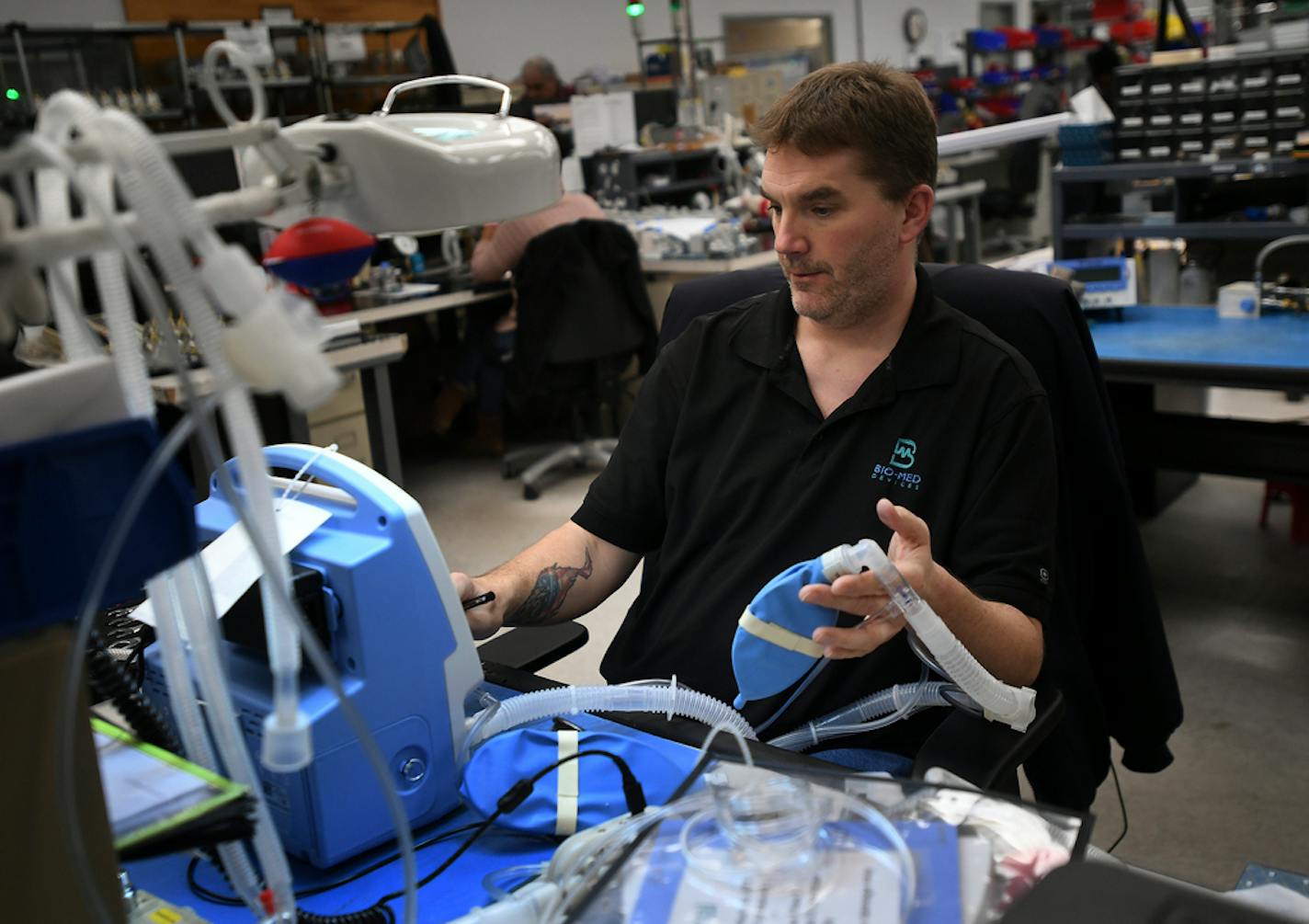 Service Manager Keith Wilson tests a TV100 ventilator at medical equipment manufacturer Bio-Med Devices in Guilford, Conn. on Sunday, March 29, 2020.