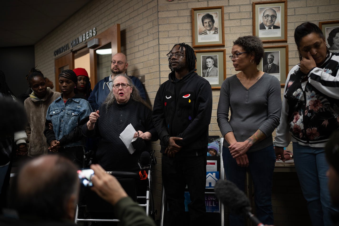 Michelle Gross, president of Communities United Against Police Brutality, center left, spoke at a news conference outside the Brooklyn Center City Council Chambers in City Hall Monday night.