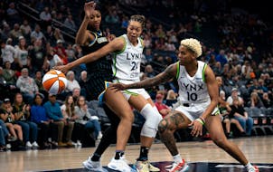 Lynx players Napheesa Collier (24) and Courtney Williams (10) work to control the ball during the first quarter Friday during a preseason game against
