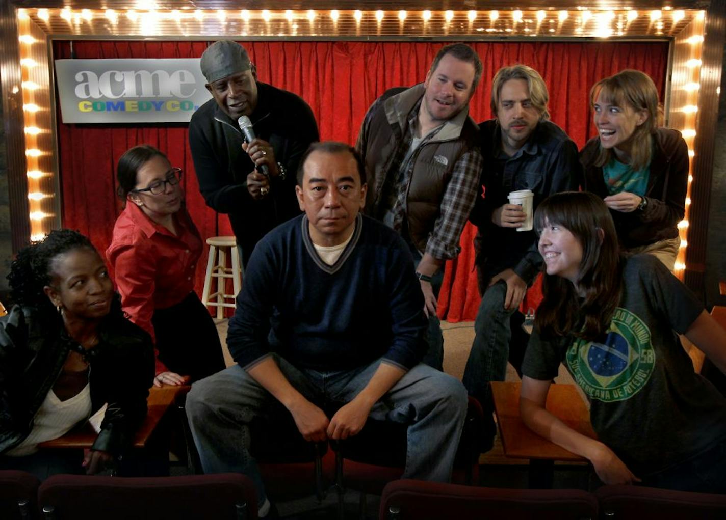 Louis Lee almost smiled at the antics of Acme performers, from left, Shannan Paul, Amber Preston, C. Willi Myles, Kjell Bjorgen, Ben San Del, Mary Mack and Andy Erikson.