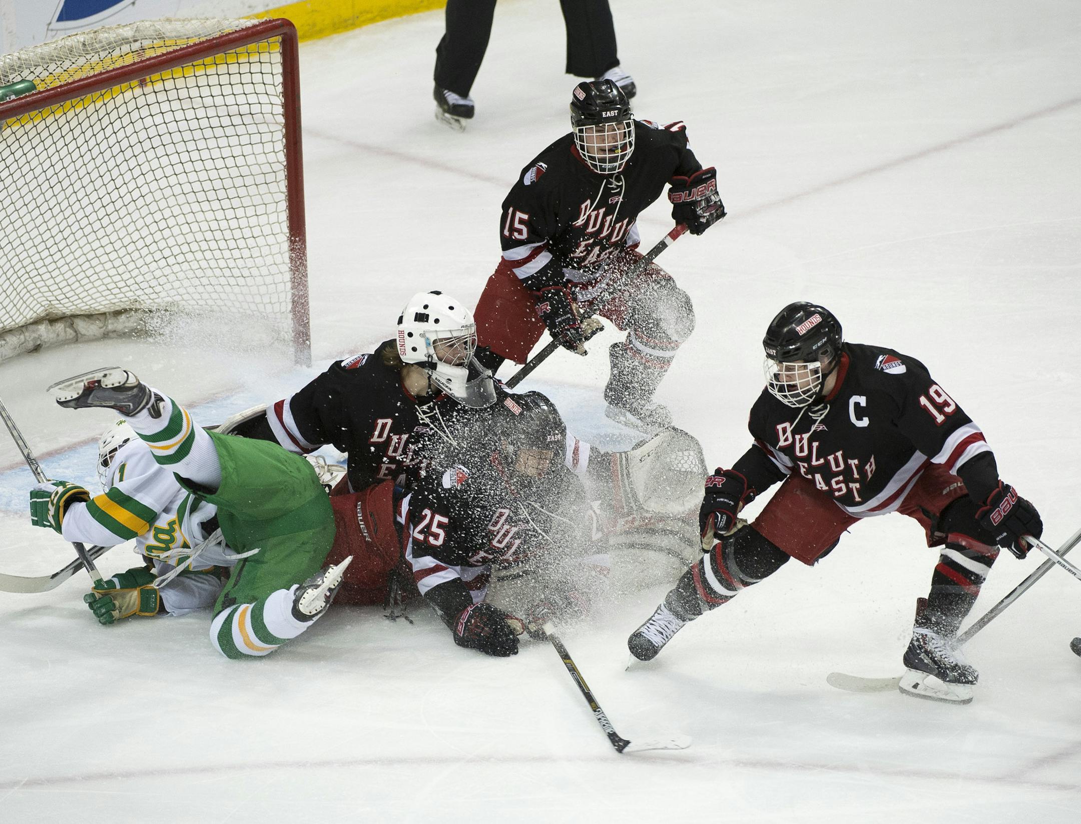 Players collide near Duluth East's goal during the first period. ] (Aaron Lavinsky | StarTribune) Duluth East plays against Edina in the Class 2A semifinals on Friday, March 6, 2015 at Xcel Energy Center.