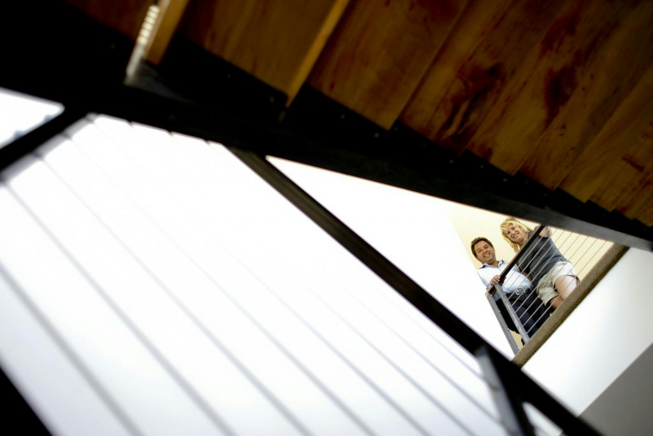 Homeowners Dave and Chip Solner look down their main staircase, created out of the trees that destroyed their property during a windstorm, in Apple Valley, Minn. on Tuesday, Aug. 7, 2012.