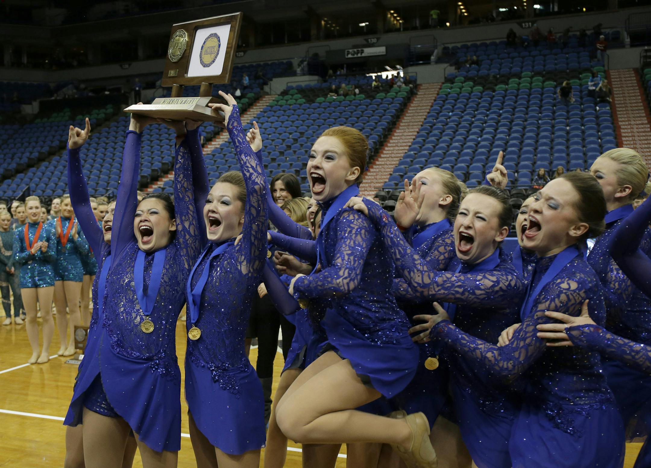 Members of the Eastview dance team celebrate with the first-place trophy after winning the Class AAA state dance tournament jazz competition finals in Minneapolis, Friday, Feb. 14, 2014.