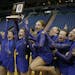 Members of the Eastview dance team celebrate with the first-place trophy after winning the Class AAA state dance tournament jazz competition finals in