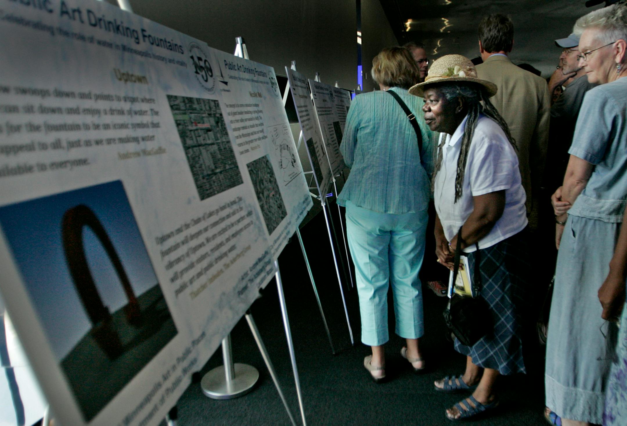 Local artist Naima Richmond got a closer look at the art designs that were unveiled at a news conference Tuesday at the Guthrie Theater. Ten new public art sculptures that will include water fountains will be built throughout Minneapolis. The art and fountain sites were chosen by the Minneapolis Arts Commission. None of the fountains is ready for installation. Sponsors are still being sought for five of the pieces.